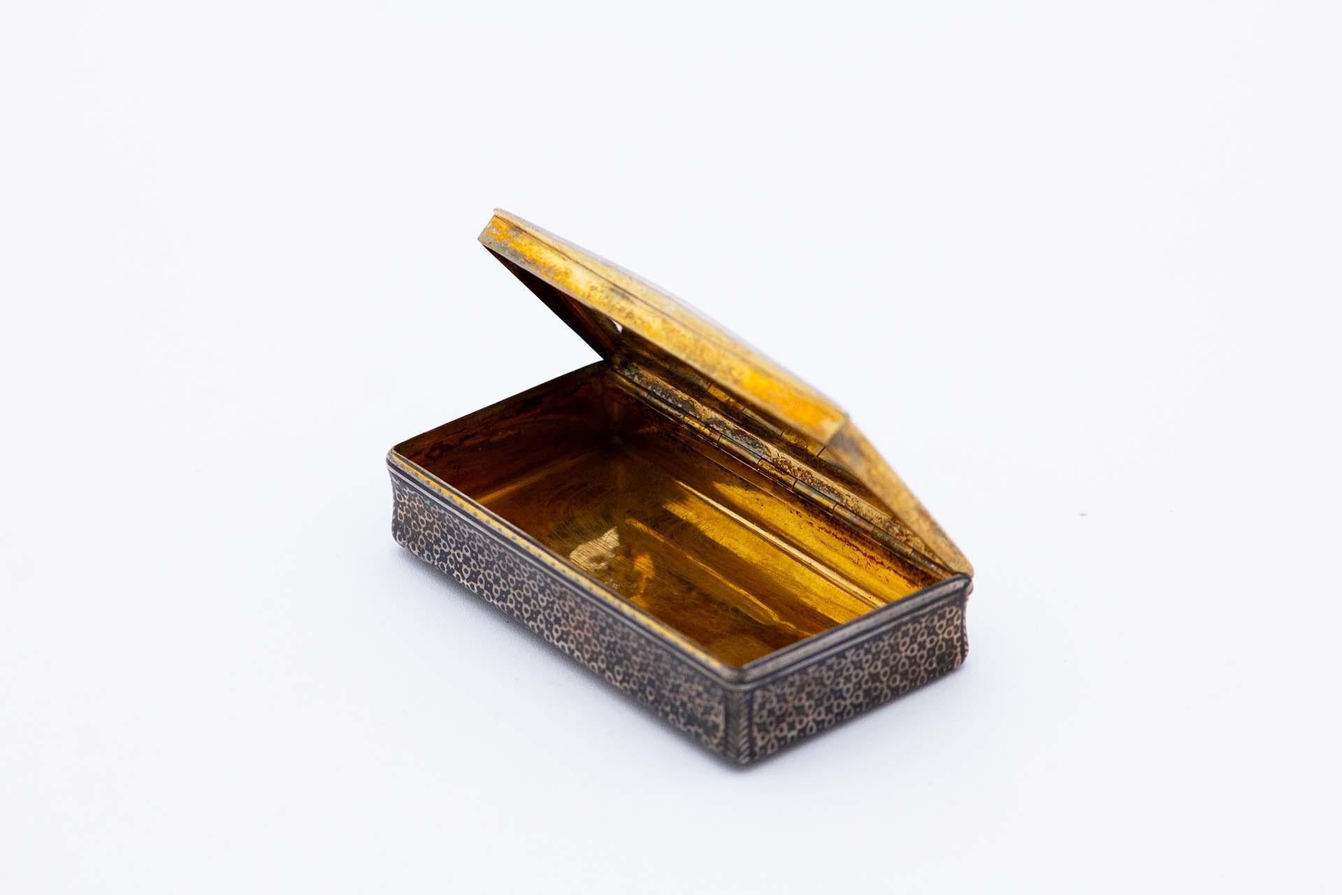 Beschreibung: Rechteckige Schnupftabakdose aus vernickeltem Silber mit der Abbildung einer gotischen Kathedrale auf dem Deckel und einer goldenen Innenausstattung. Metall: Silber. Herkunft: Französisch. Marke: Tête Minerve. Gewicht: 98,74 Gramm.