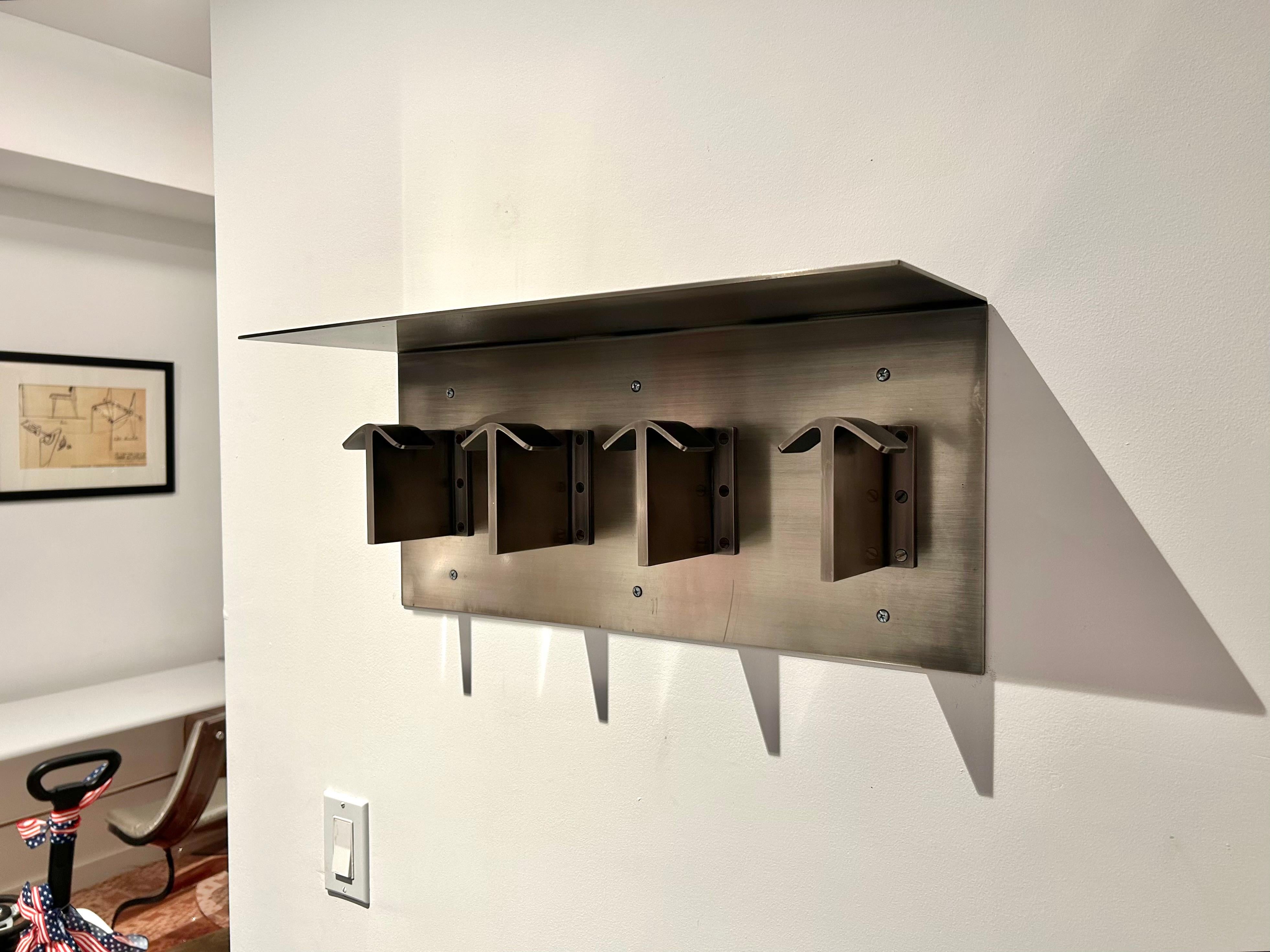 Custom and studio-made wall mounted coat rack with a top shelf, well crafted and heavy, in the style of a Robert Mallet-Stevens’ early 1920s design. The coat/hat rack is made from 1/8” thick solid brass that was plated in nickel with an antiqued,
