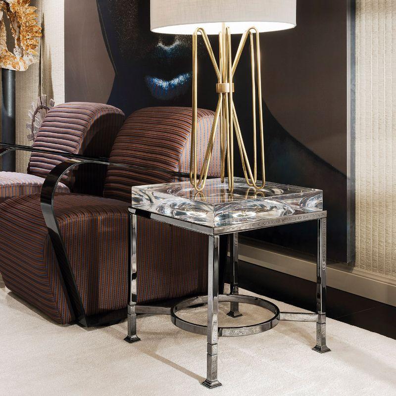 Timeless refinement characterizes this splendid side table, entirely handcrafted of black nickel and methacrylate and showcasing spectacular geometric lines of bold visual impact. This design is ideal to complement both classic and modern interiors.