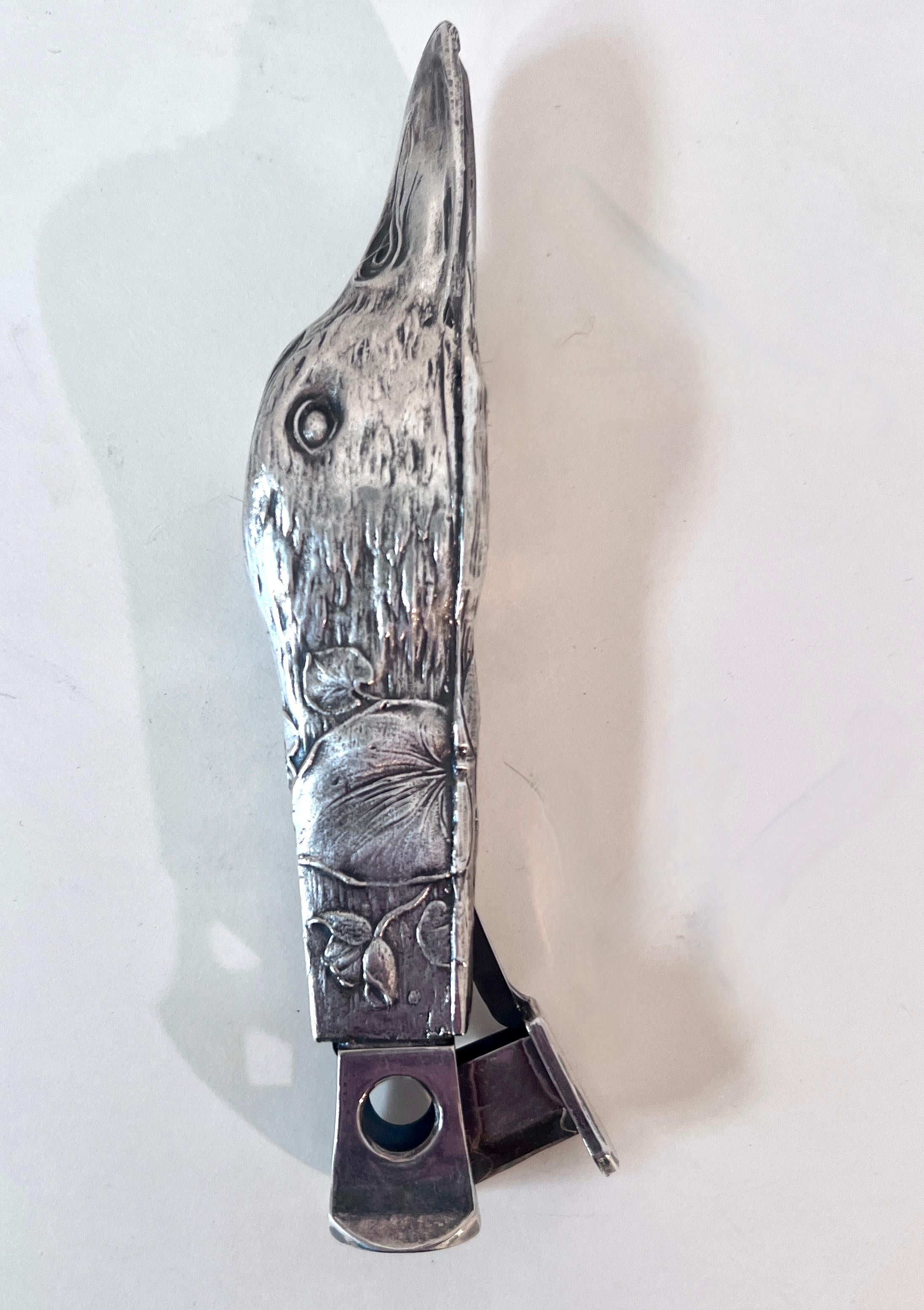 Nickel Silver Cigar, Cigarette or 420 Cutter in the form of a Repoussé Duck 

A wonderfully decorative piece, also in great working condition to cut 420 or Cigars.  A compliment to 
any smoking room, bar or desk.

The Repoussé Duck is very well