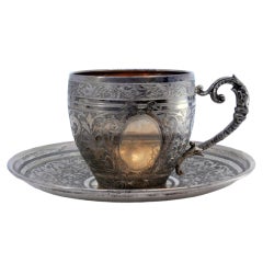 Nickel silver cup and saucer with floral engravings and monogram panel