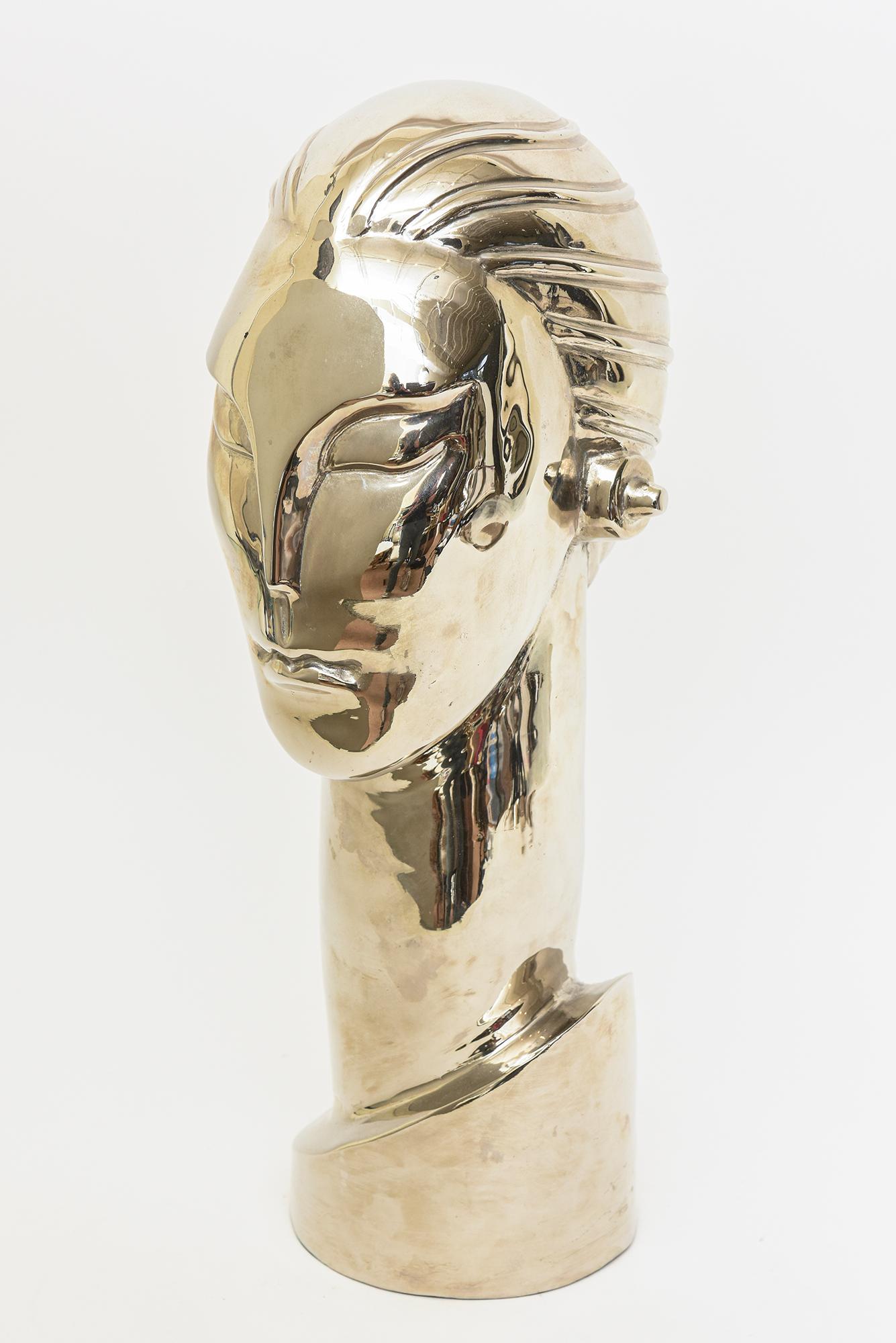 This very stylized elongated chic figurative head bust sculpture has been nickeled silver over the brass over 15 years ago and looks amazing. New green felt was placed on the bottom. The elongated and exaggerated neck adds to the interest. It is an