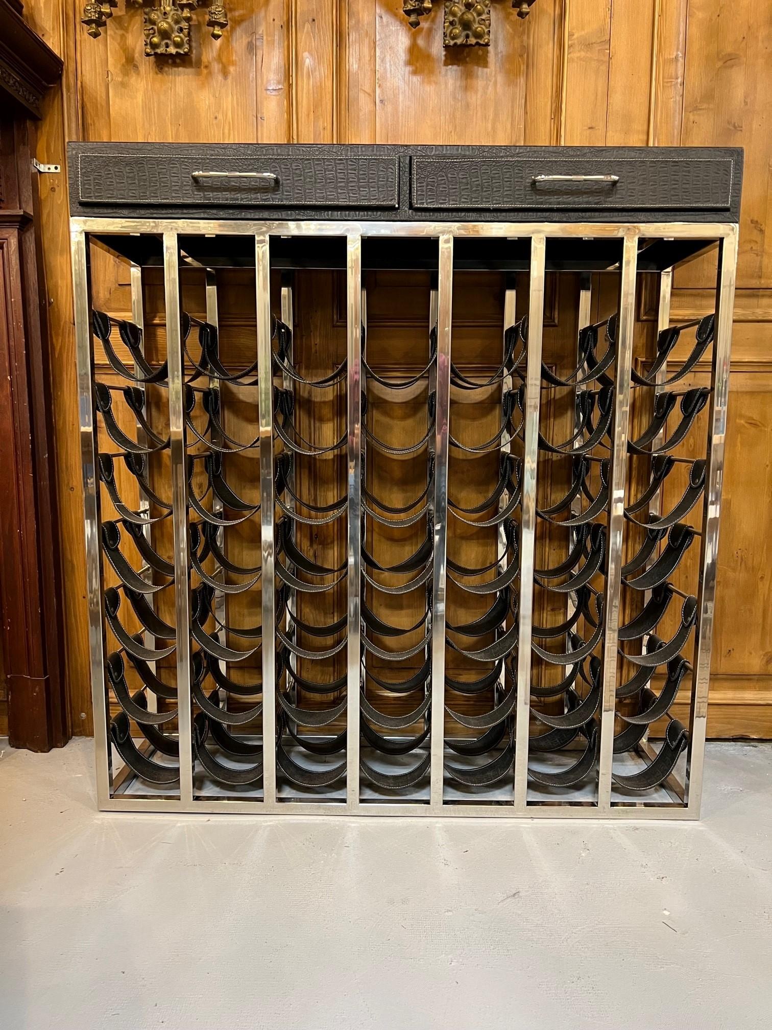 Exceptional 49 bottle nickel plated wine rack console with saddle leather holders and a leather top with two drawers. The bottle space is a good size 5.50 x 13.50 which can hold larger bottles. This is a new wine rack imported from India around 2015