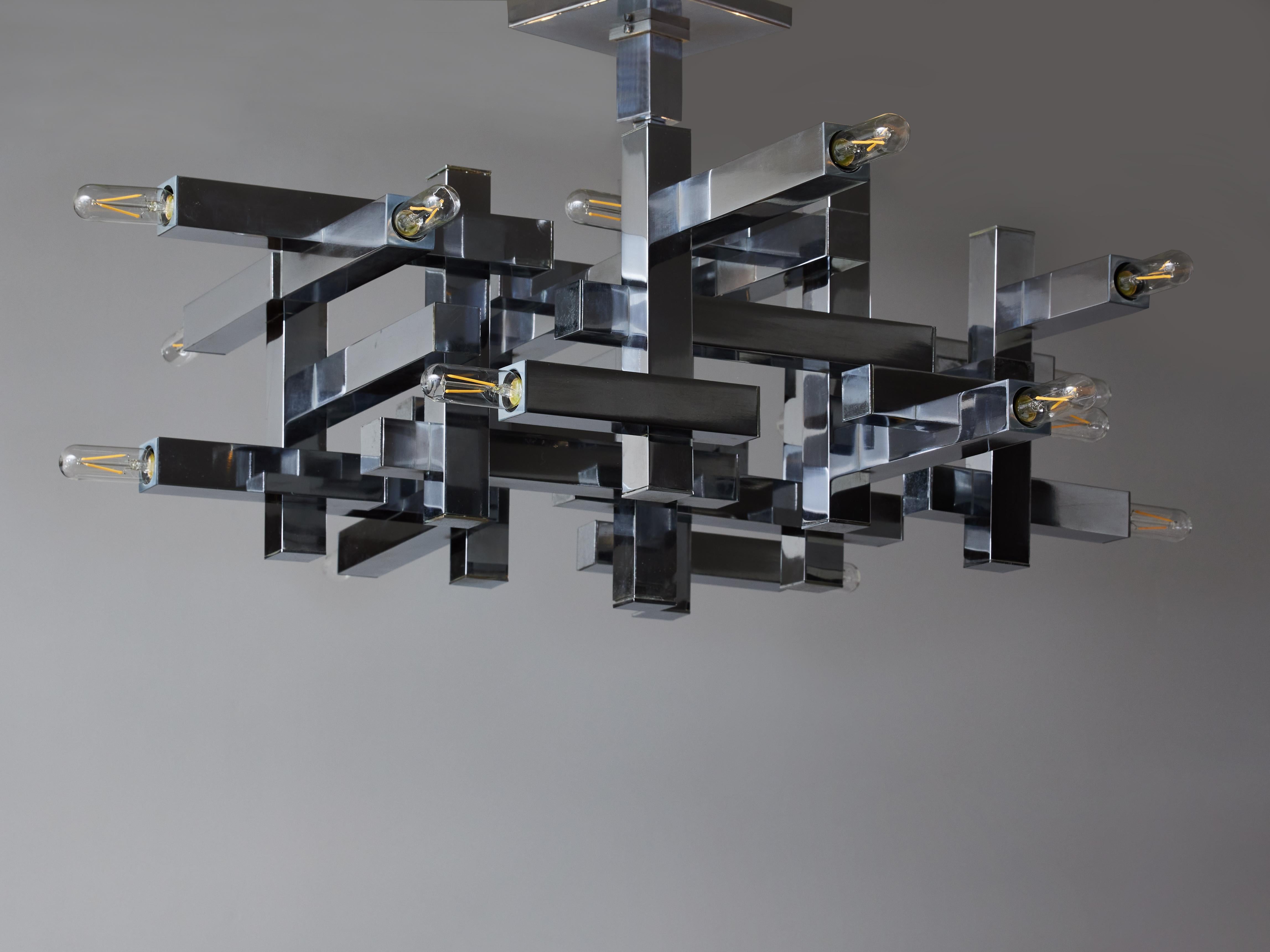 Cubist chandelier by Gaetano Sciolari made of square tubes geometrically assembled from which come out eighteen sources of light. 

Angelo Gaetano Sciolari 
Angelo Gaetano Sciolari (1927-1994) was the owner of Sciolari Lighting and designer for