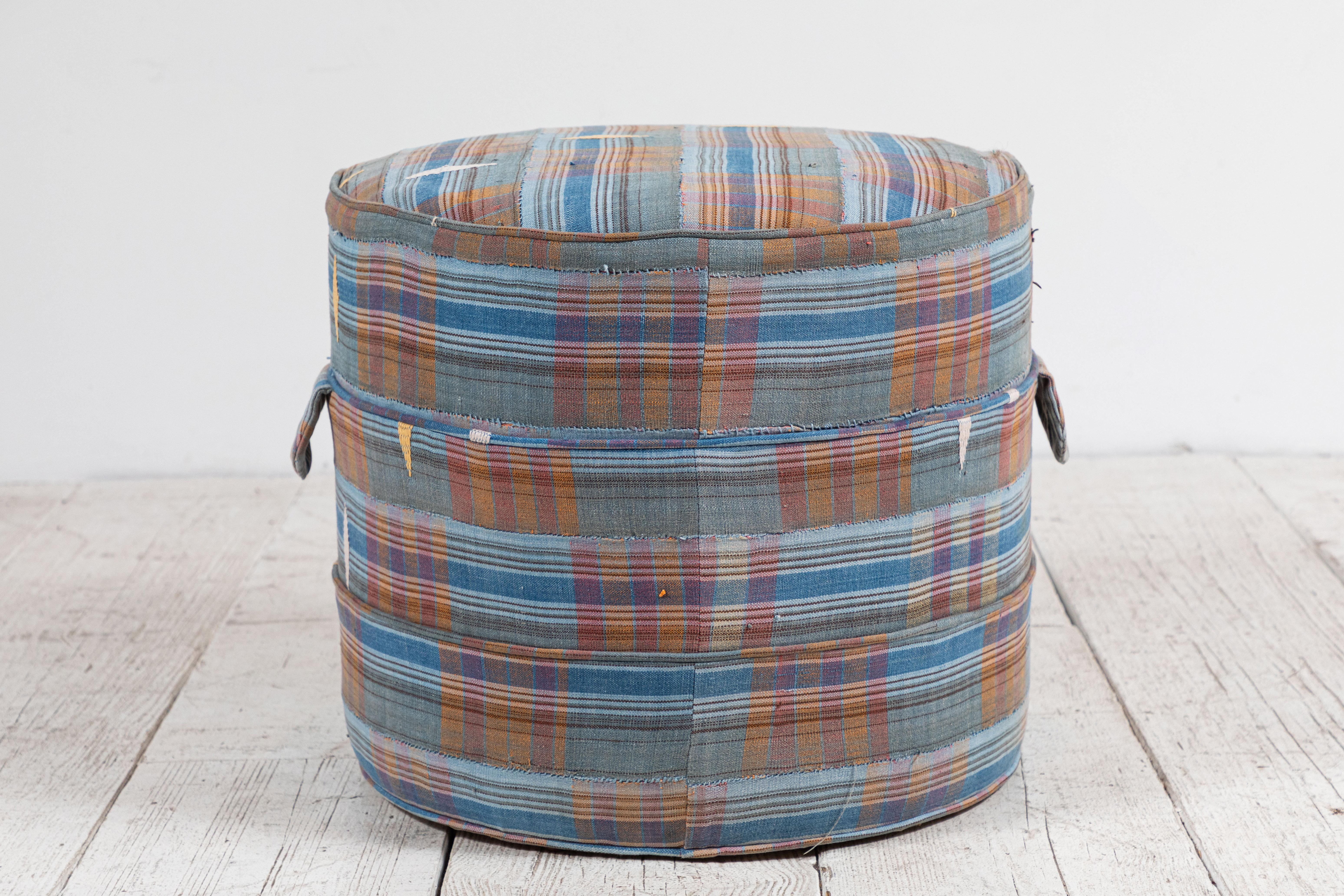 Solid wood frame and upholstered hassock with two ring piping and double handle details offers versatility in accent seating. Please enquire regarding custom sizes.

This specific hassock is upholstered in one of a kind African fabric.