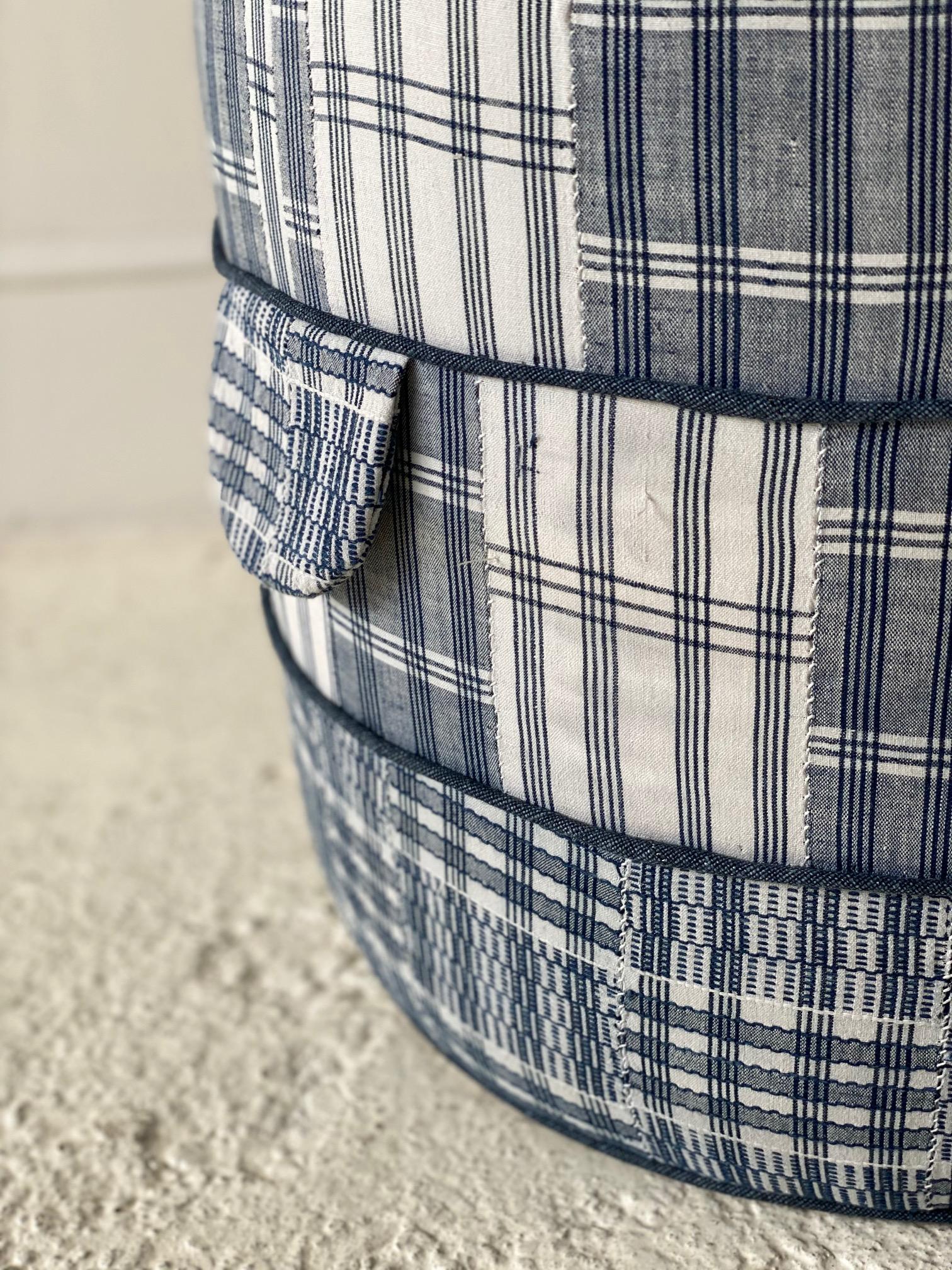 Solid wood frame and upholstered hassock-ottoman with two ring piping and double
handle details offers versatility in accent seating. This specific hassock is upholstered in a one of a kind blue and white vintage African textile.