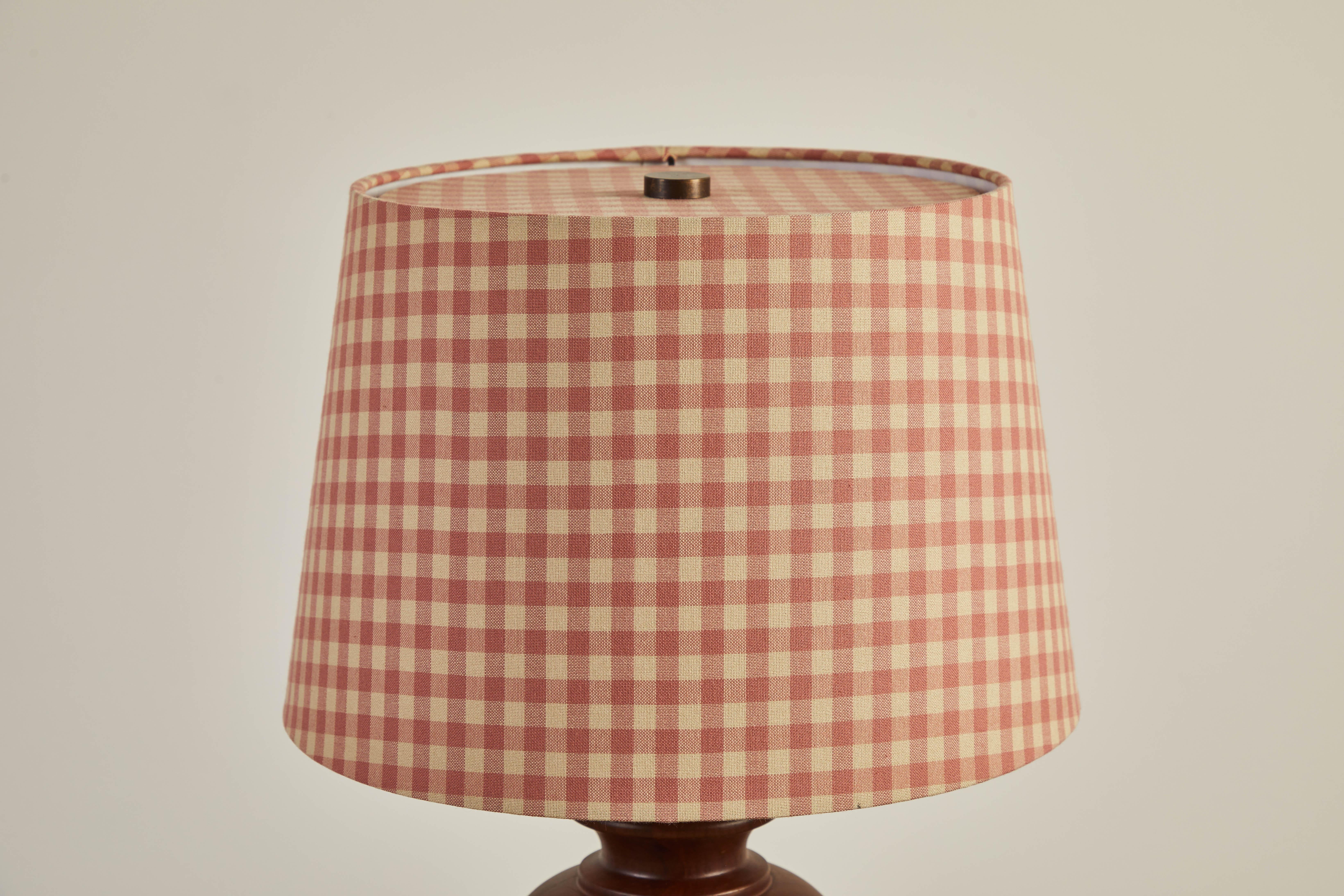 Nickey Kehoe collection urn lamp made from hand-turned walnut. Custom shade made from vintage check fabric.