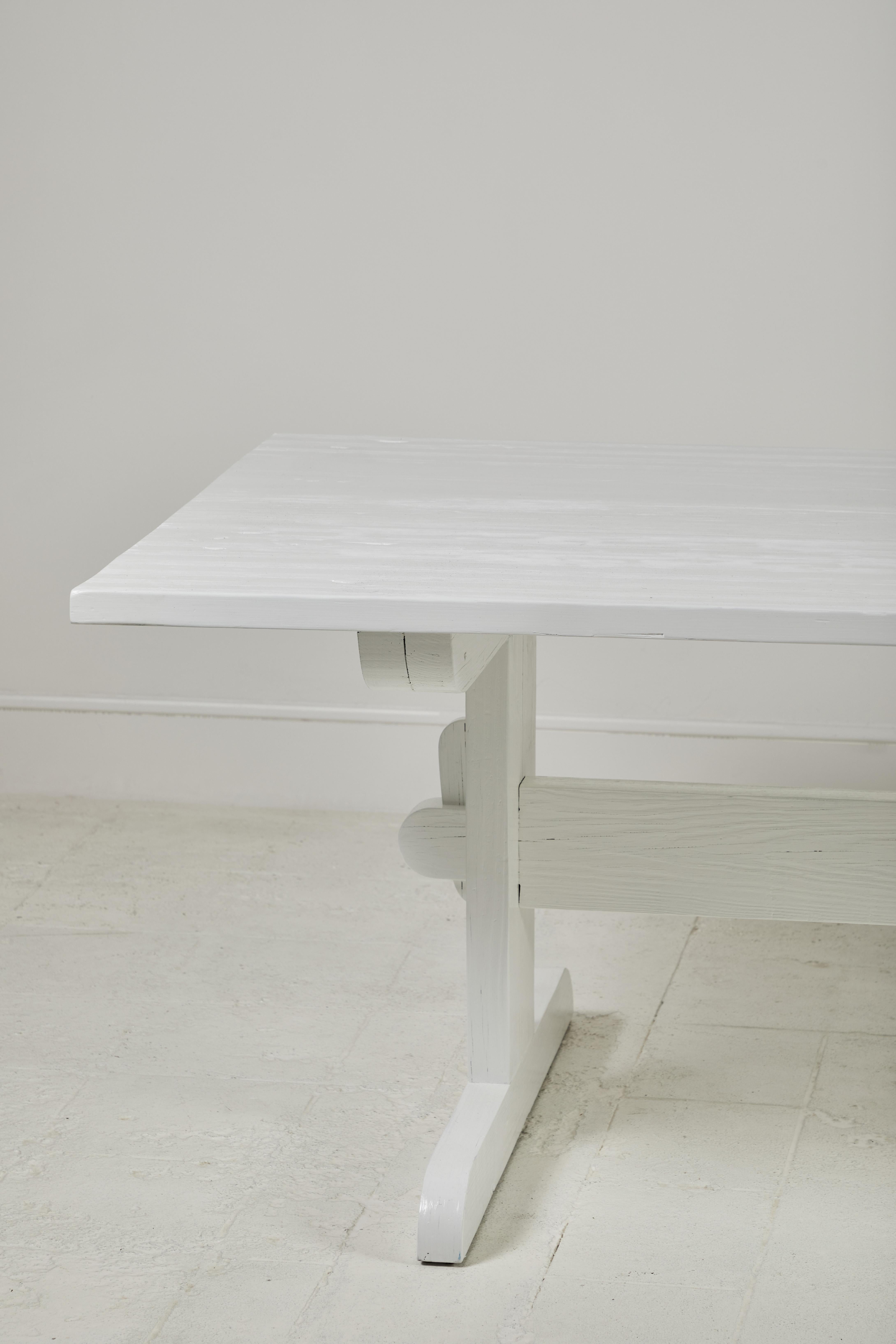Nickey Kehoe collection white painted trestle dining table:

Beautiful handmade dining table utilizing wide-plank reclaimed yellow pine. The rectangular shape with trestle base boasts both pragmatism and elegance. Natural sun-bleached finish