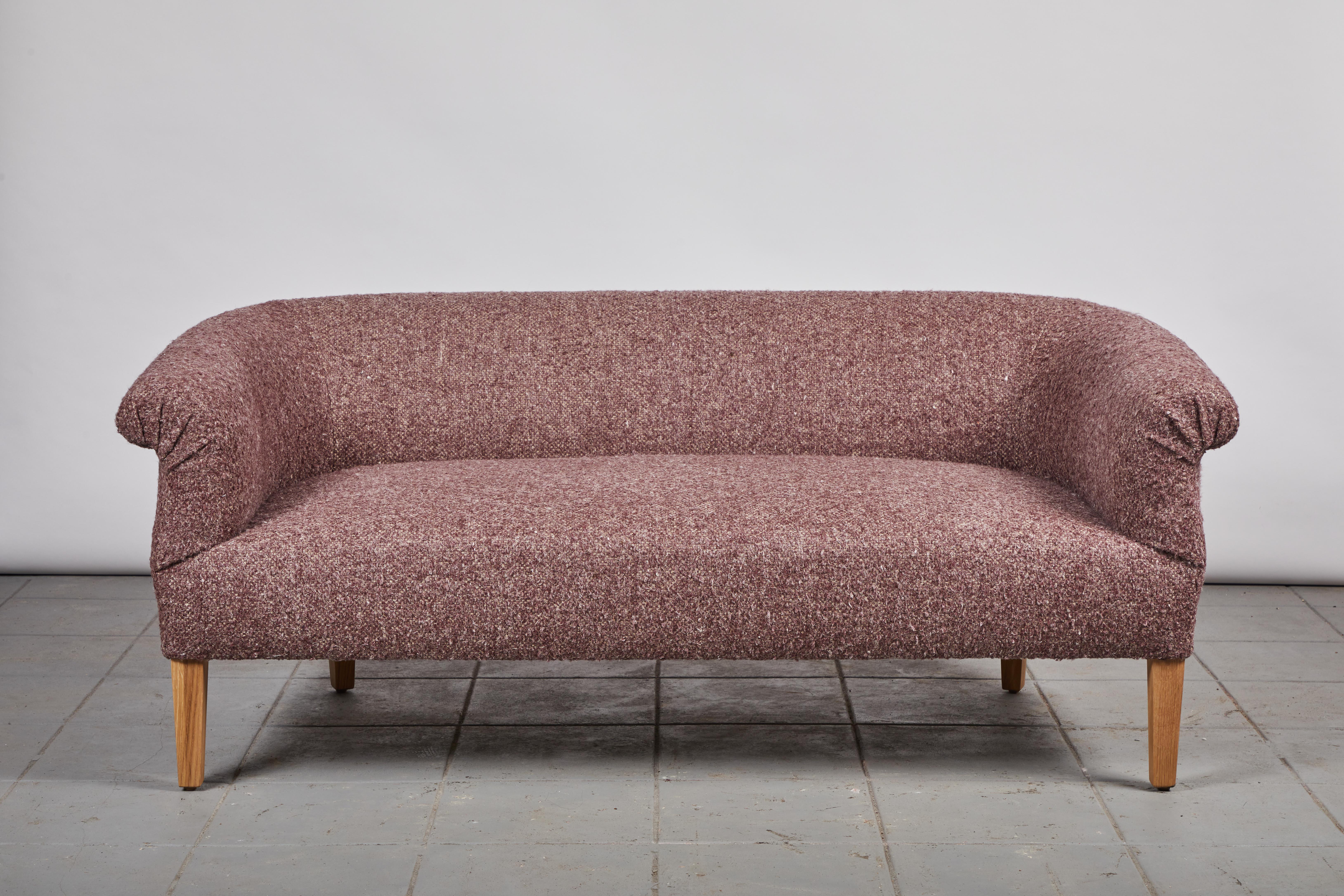 This comfortable and elegant settee showcases old-world design paired with a contemporary sensibility. Perfect for the end of a bed or under a window, this beauty is versatile and elevated. This specific settee is upholstered in a merlot colored
