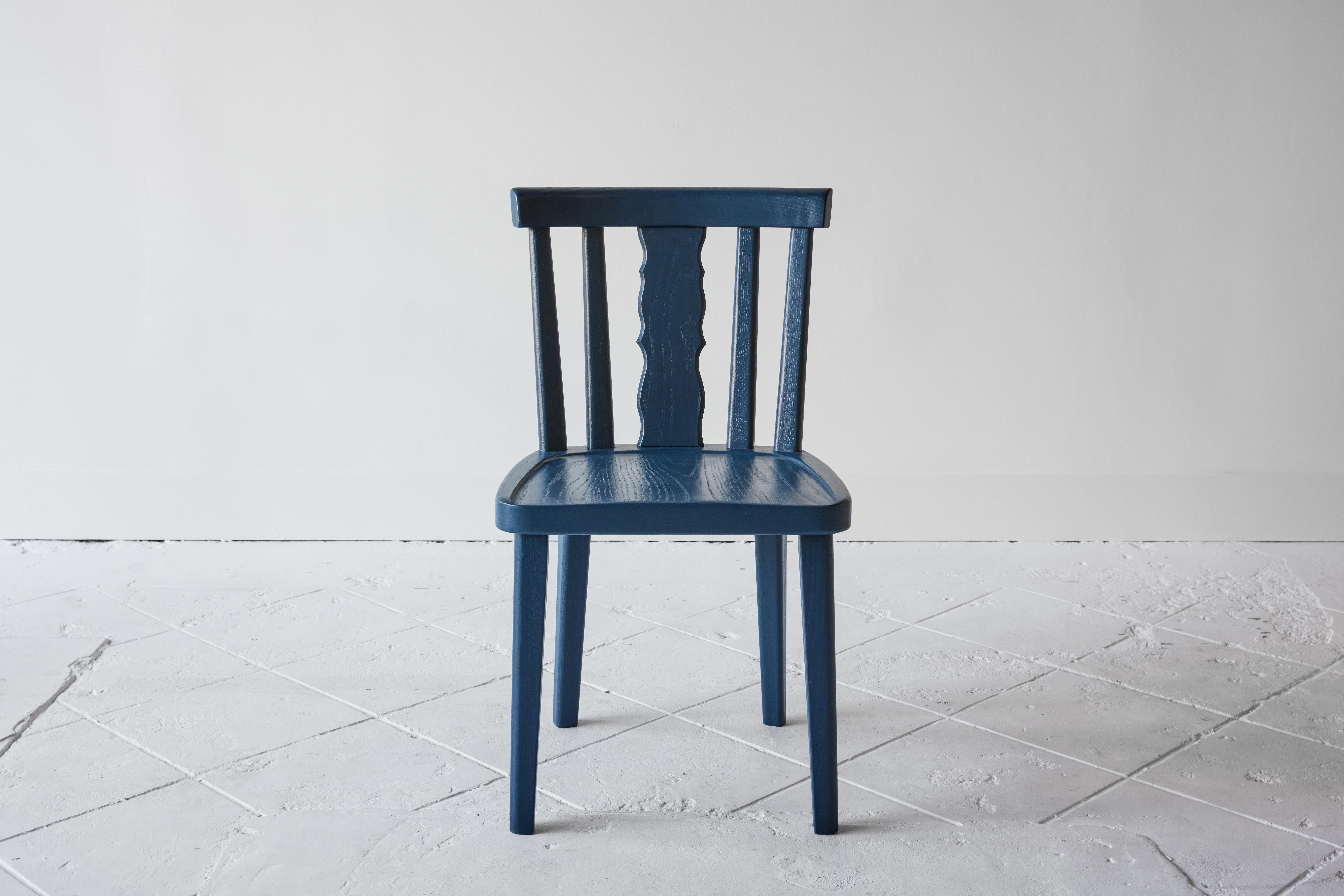 This comfortable dining chair boasts an open silhouette inspired by rustic European style that is both spectacularly simple and elegantly detailed. Handcrafted in Douglas fir and painted in our signature blue. Set of four.
