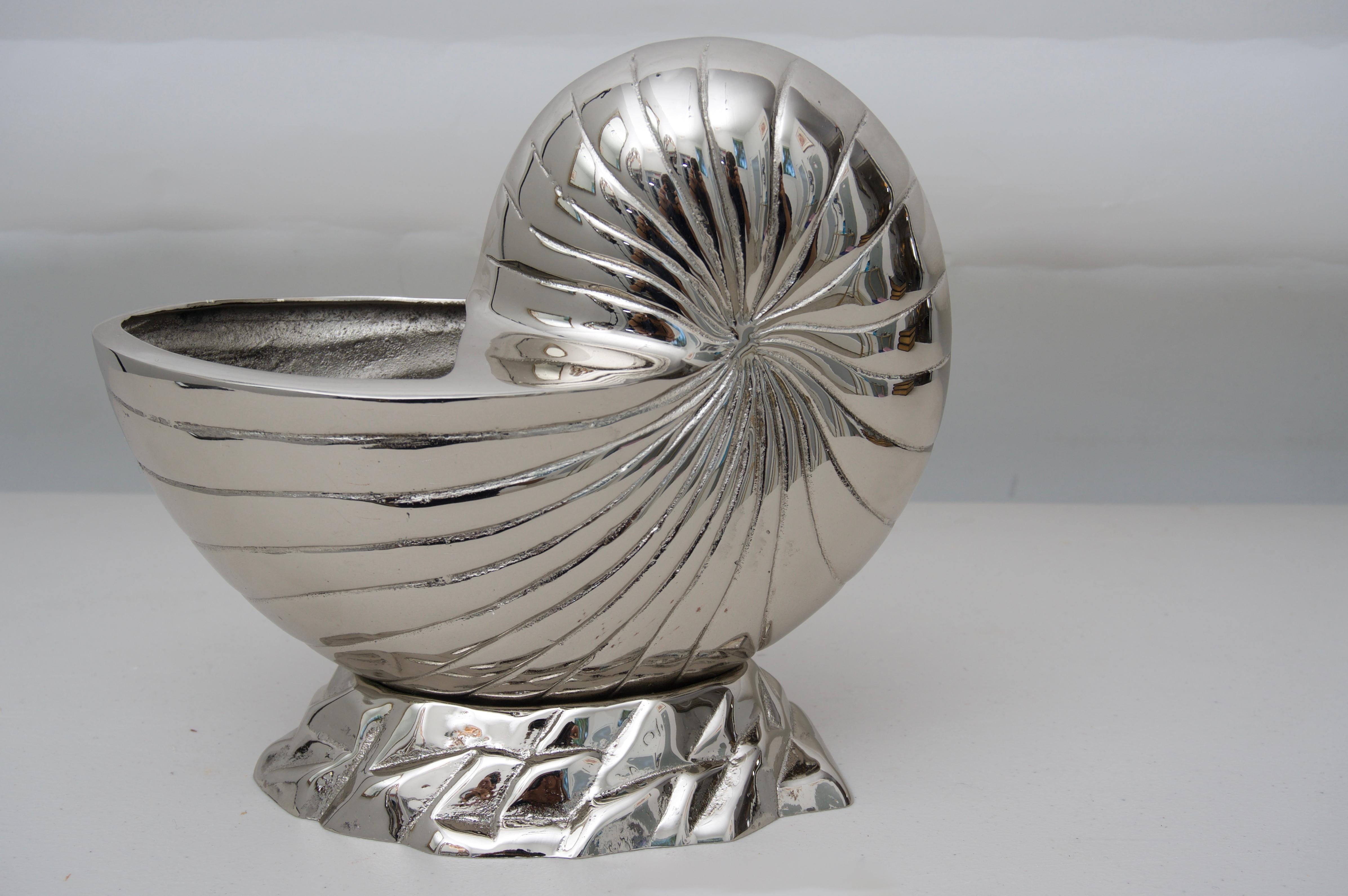 This stylish nautilus-form piece is a custom piece by Iconic Snob Galeries and could be used as a cachepot or perhaps as a serving piece. The piece is lacquered so no polishing.