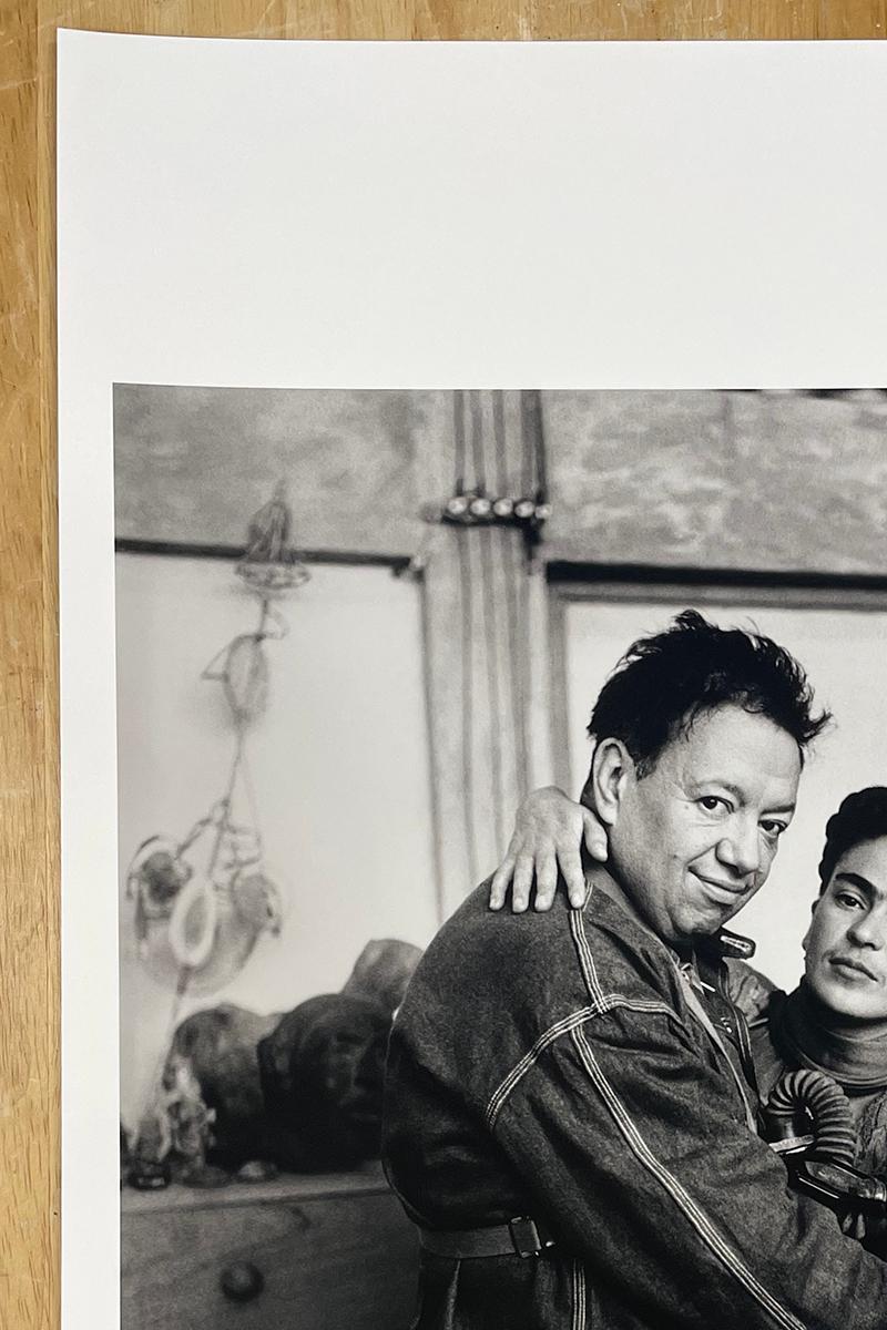 Frida and Diego with Gas Mask is a limited edition black and white portrait of Mexican painters Frida Kahlo and Diego Rivera. The couple embraces each other while Frida holds a gas mask in her hand.

Archival Pigment Print
Paper size: 19 x 13 in.,