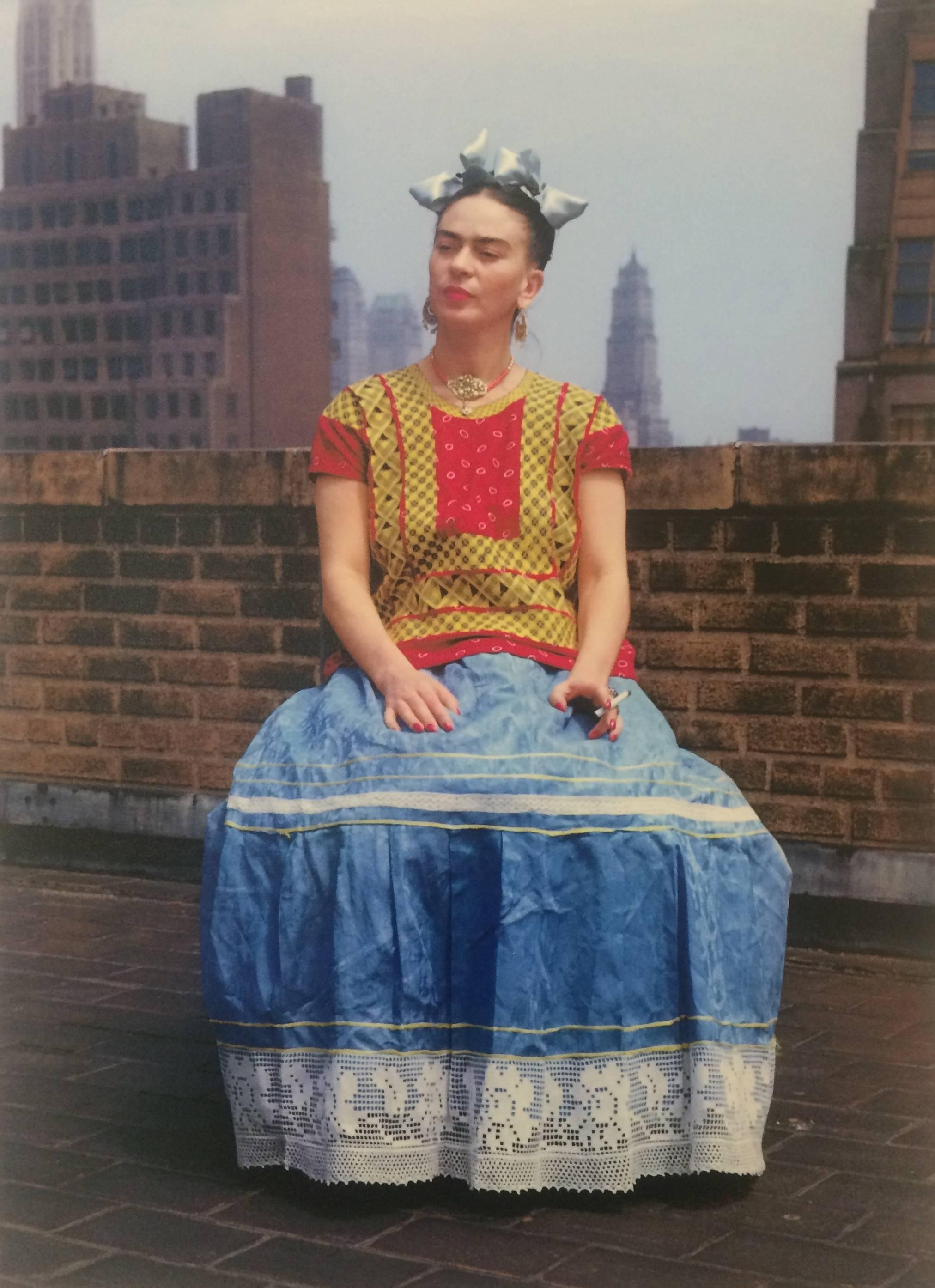 Nickolas Muray Portrait Photograph - Frida Kahlo (Sitting on roof holding cigarette), 1946