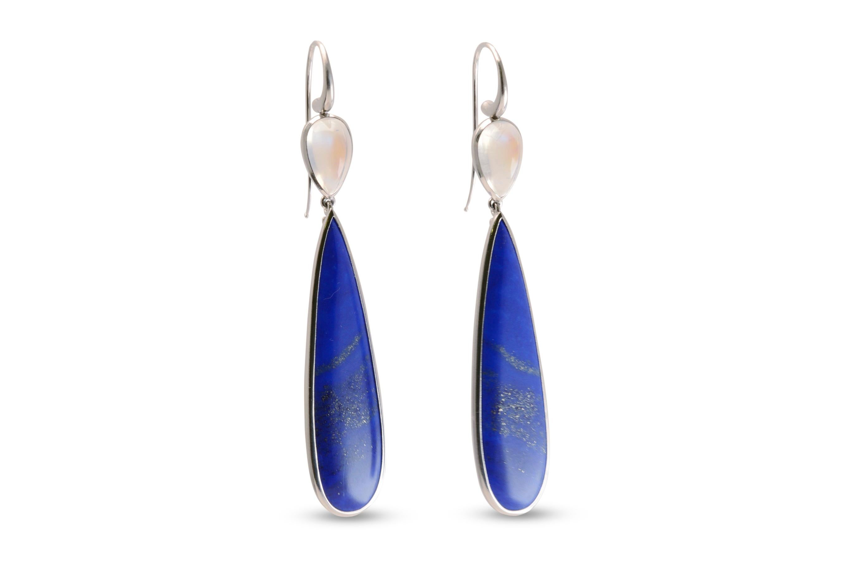 Clean elegant lines and luscious coloured gemstones combine to create these statement Nicky Burles drop earrings. Two elongated pear shaped lapis lazuli totalling 44 carats feature in a fine platinum bezel setting, topped with a pair of luminous