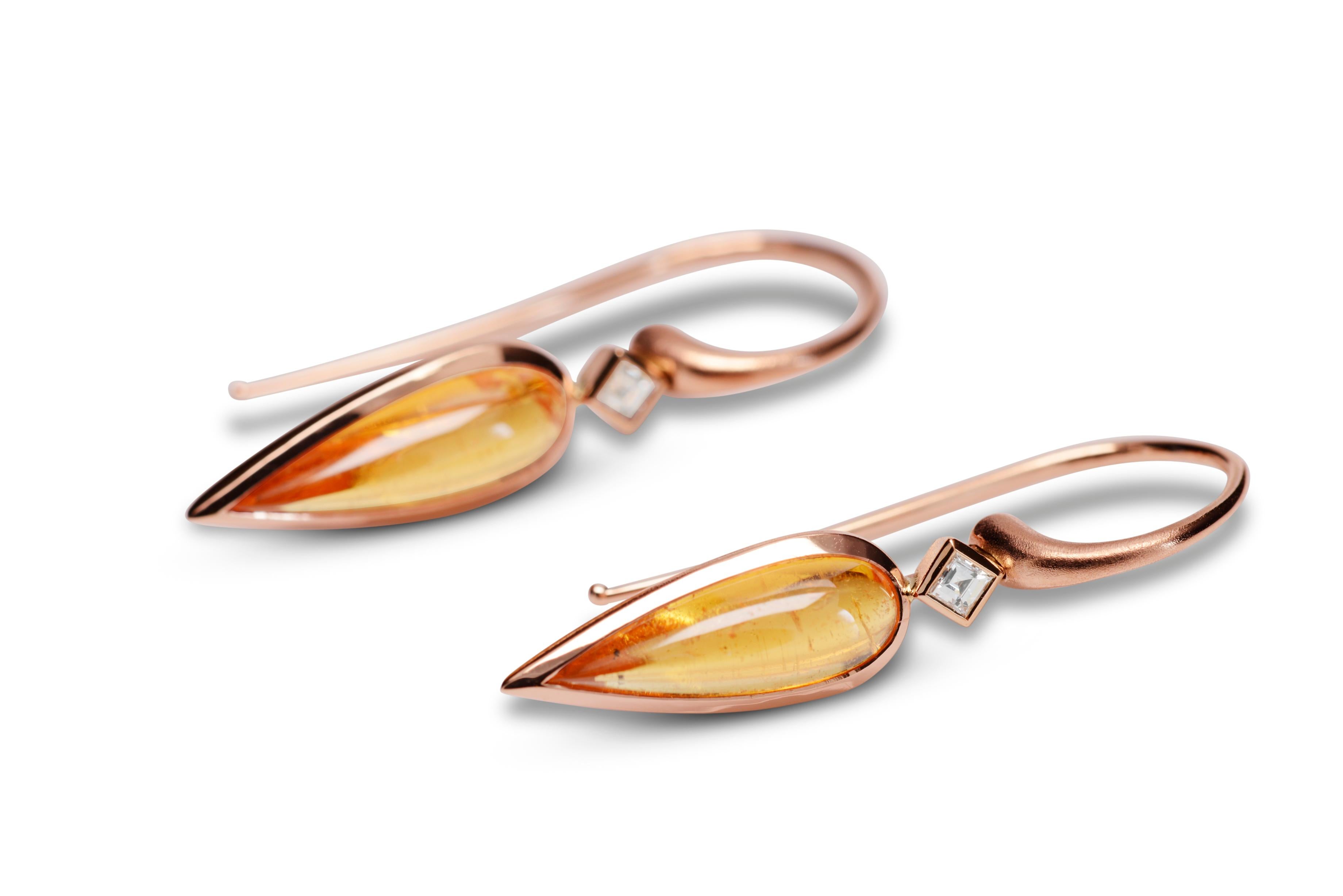 Simple, elegant contemporary design and luscious coloured gemstones combine to create these signature Nicky Burles drop earrings. Two elongated pear shaped mandarin garnets totalling 5.60 carat feature in a fine 18 karat rose gold bezel setting,