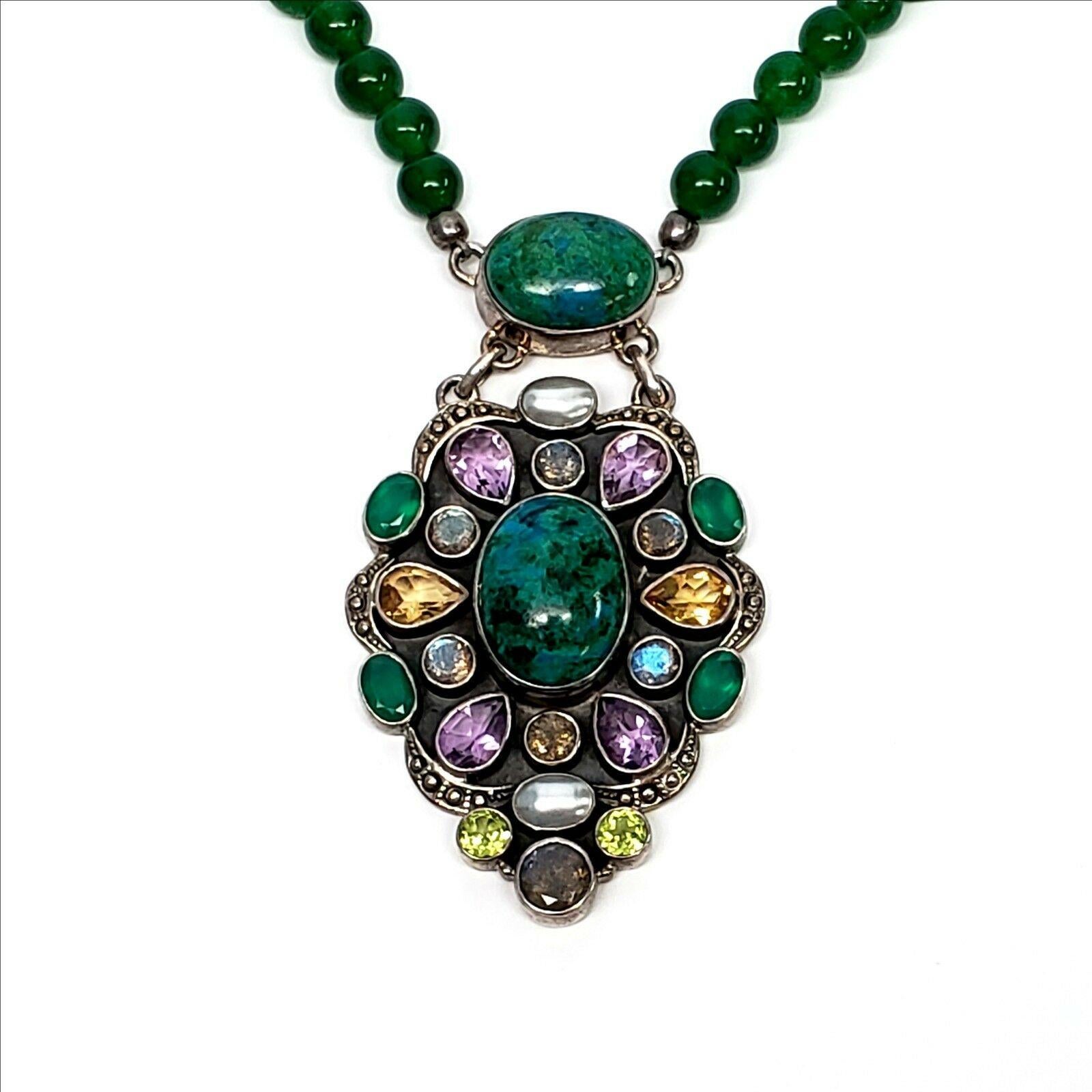 Nicky Butler Sterling Silver and multi-gemstone beaded necklace with large pendant.

This is a unique limited edition piece from Nicky Butler's Raj collection featuring a green quartz beaded necklace and a large pendant with gemstones that appear to