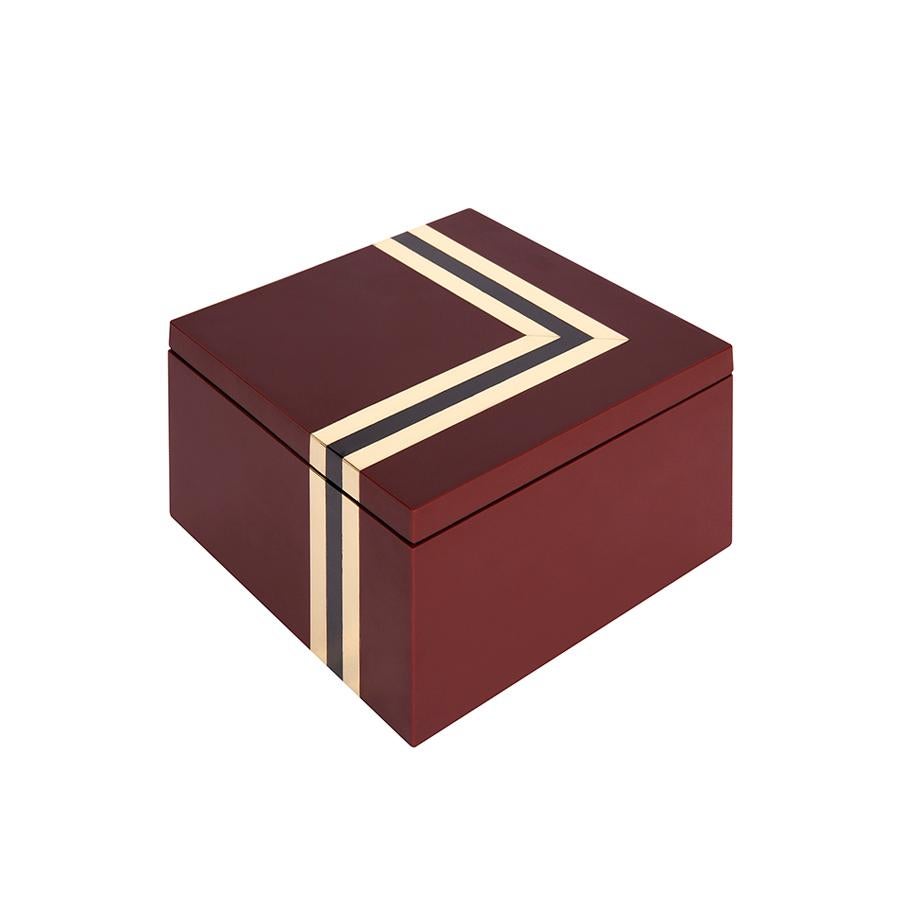 With its maroon lacquer square defined by sharp, chic stripes of black lacquer and brass, this piece takes the edgy glamour of the Nico Shell Box and gives it a look that is French Art Deco in style but disco in spirit.

Spritz on some YSL Opium,