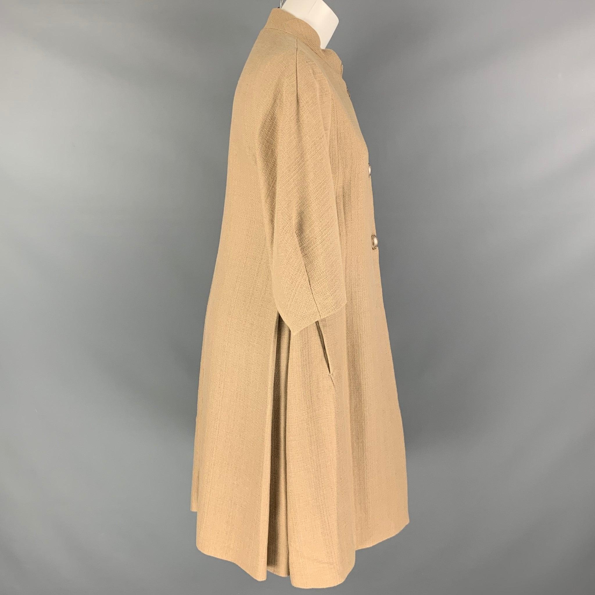 NICOLE FARHI coat comes in a beige cotton woven material featuring a novelty buttons, side pockets, 3/4 sleeves, snap button closure, and A-line silhouette. Excellent Pre-Owned Condition. 

Marked:  6 

Measurements: 
 
Shoulder: 16.5 inches Bust: