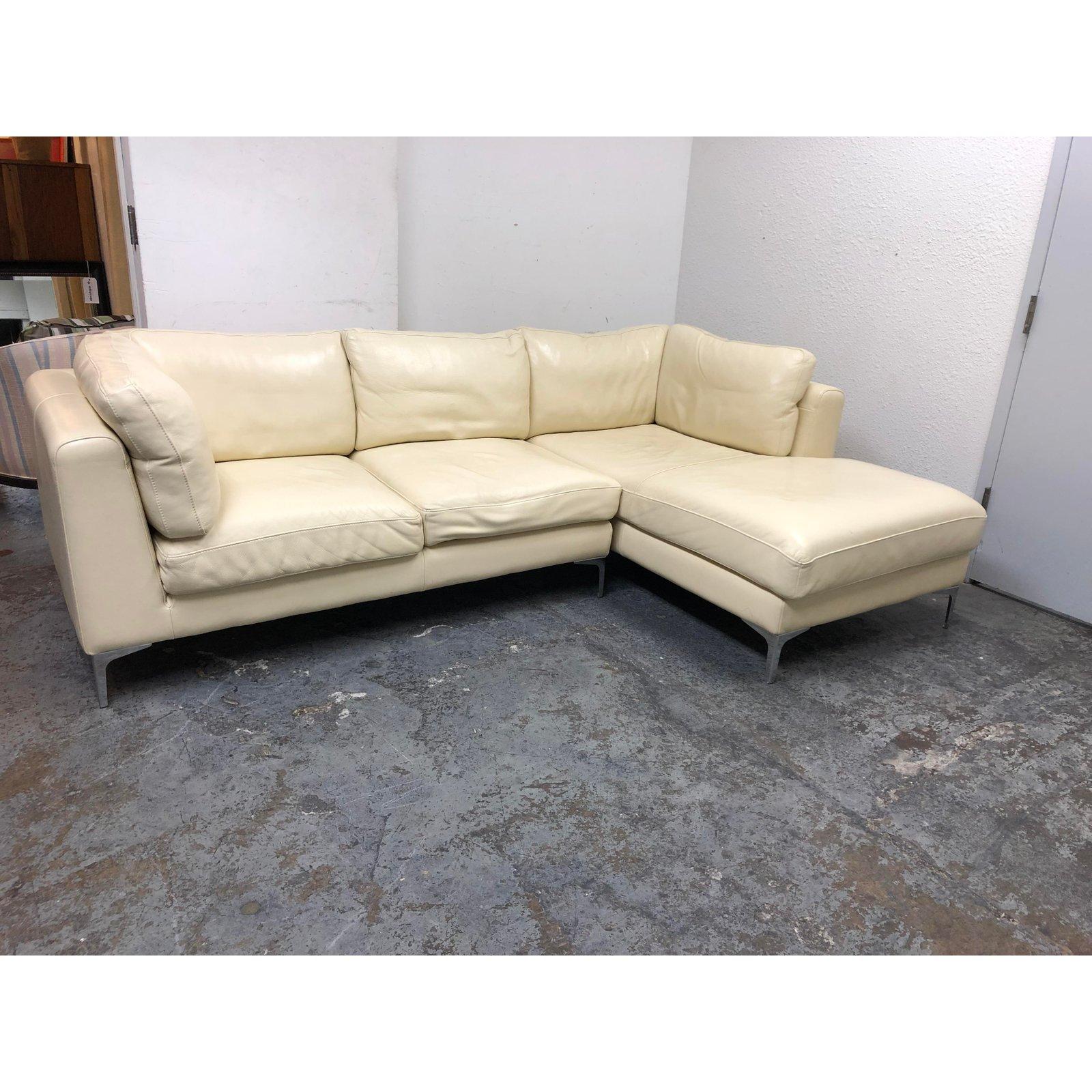 Design Plus Gallery presents a two-piece Nicoletti Sectional from Design Within Reach. Designed by Giuseppe Nicoletti. Upholstered in an Italian Buttercream color leather. The support cushions have velcro and zipper attachments to keep them in place