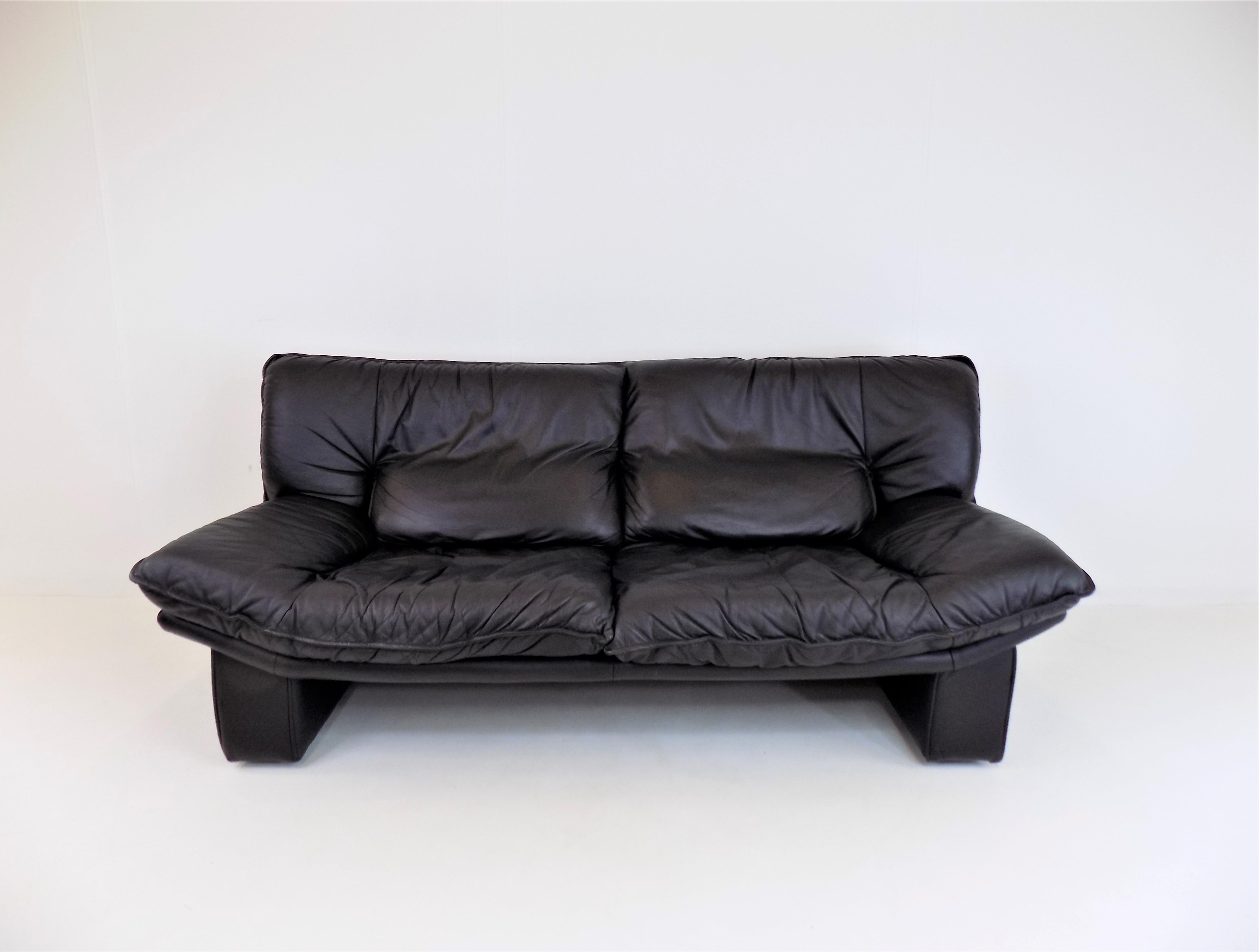 An Ambassador 2 seater black leather sofa in excellent condition. The sofa has soft leather which is in very good condition. The massive, also leather,  L pillars of the sofa are undamaged.

 

The sofa was designed by the Italian manufacturer