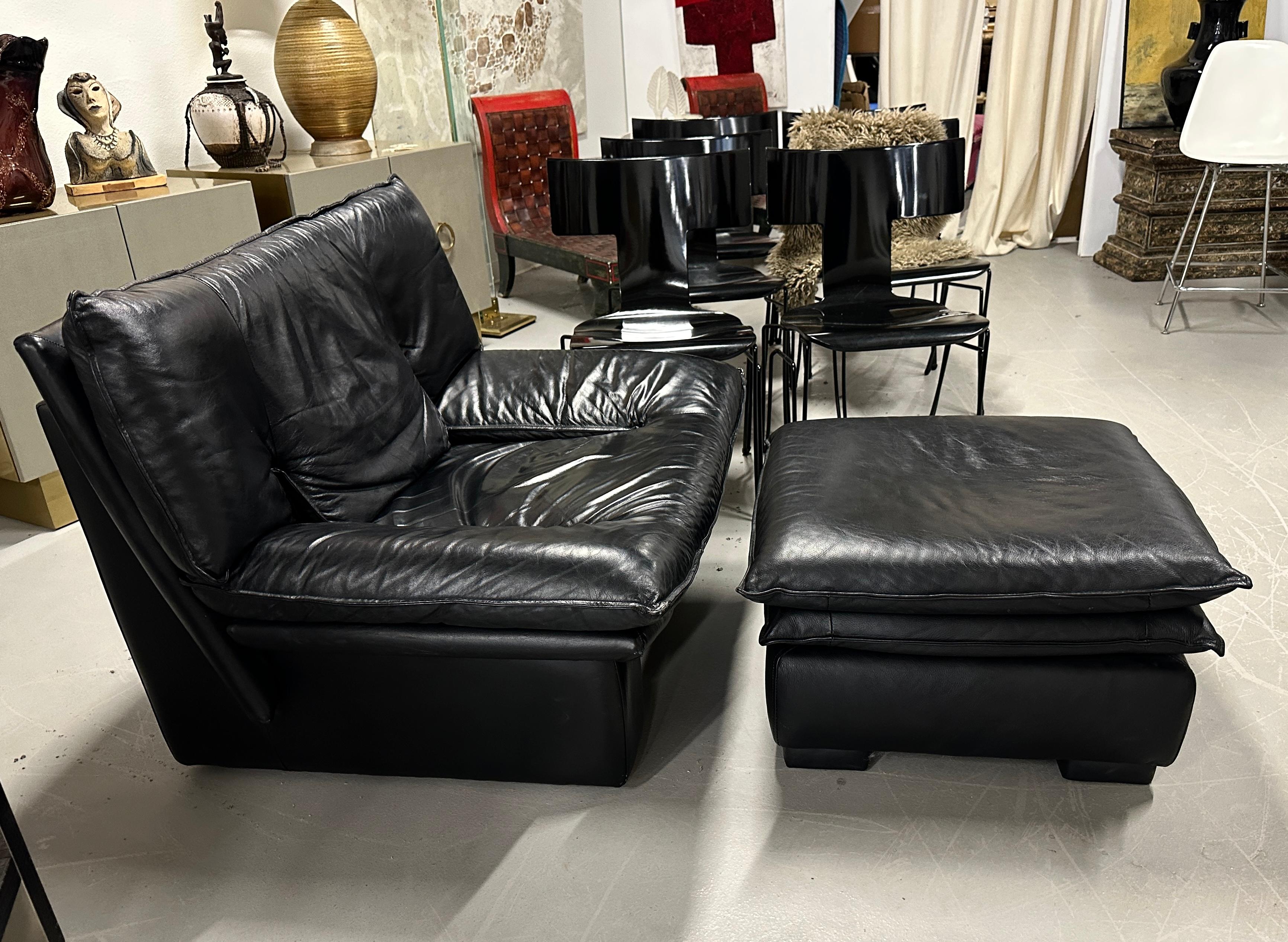 Sleek post modern lounge chair and ottoman by Nicoletti Salotti from the 1980s. Extremely comfortable. The black leather is soft and supple. The chair and ottoman are in good age appropriate condition with some minor wear and some minor rubbing to