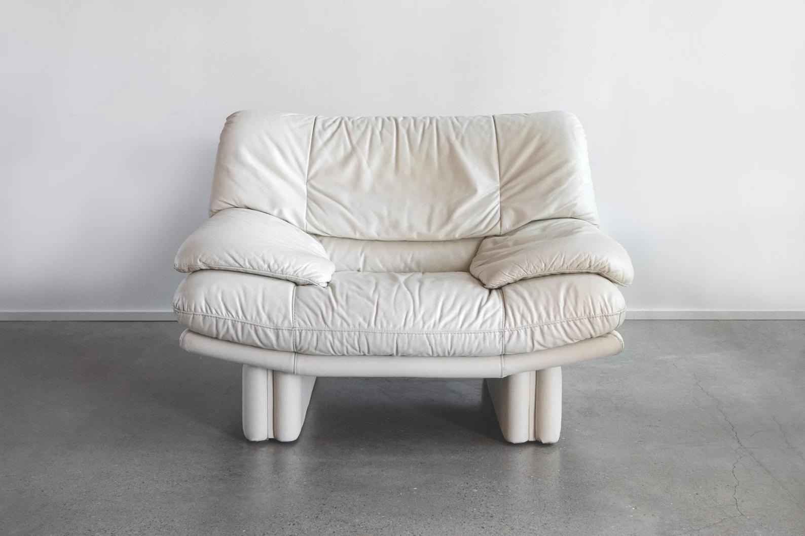 Sink in and feel like you're on a cloud with this stunning postmodern Nicoletti Salotti Italian leather chair in gorgeous a off-white cream. A statement piece in your living room or anywhere you decide to put it. Would pair nicely with modern day,