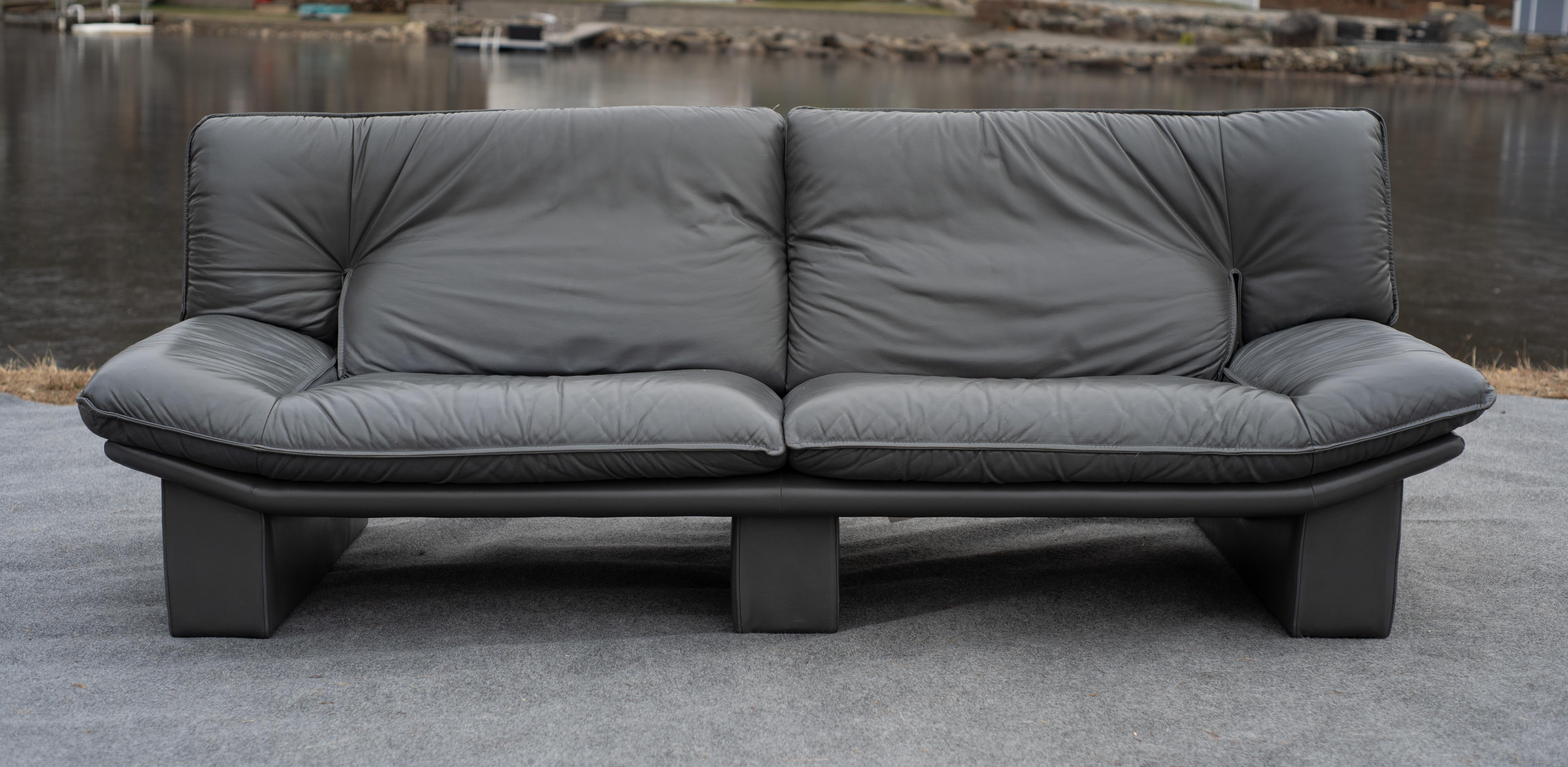 Designed and made in the 1980s, this sofa was exported from Italy after production by Nicoletti Salotti. It features signs of mid-century influence in its long and low nature and by design cues such as the slightly upturned sides, reminiscent of