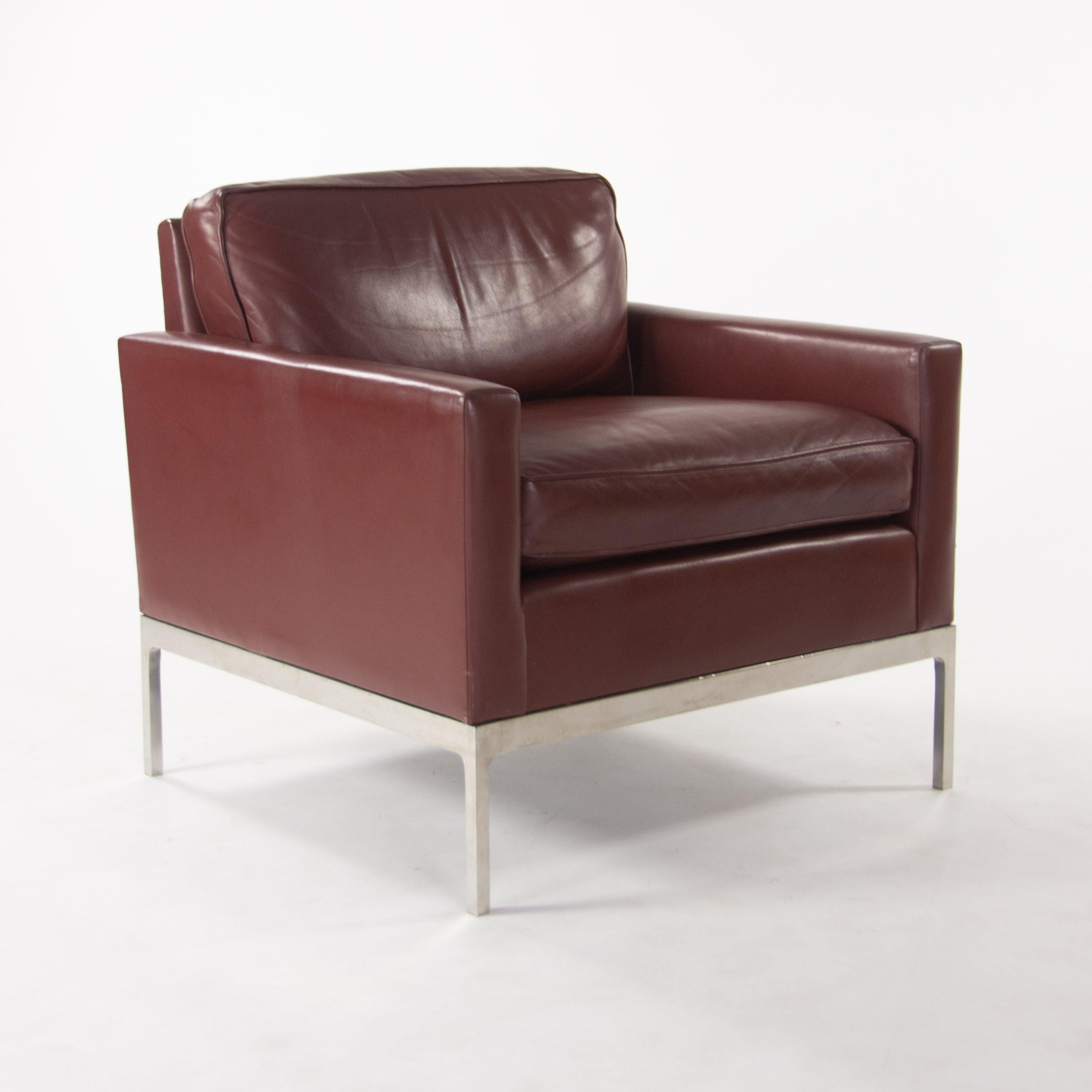 Listed for sale is an original Nicos Zographos red Leather lounge chair with arms. This example is fully upholstered in leather, with a polished stainless steel base.  
Nicos Zographos and his company (Zographos Designs ltd.) were prolific in