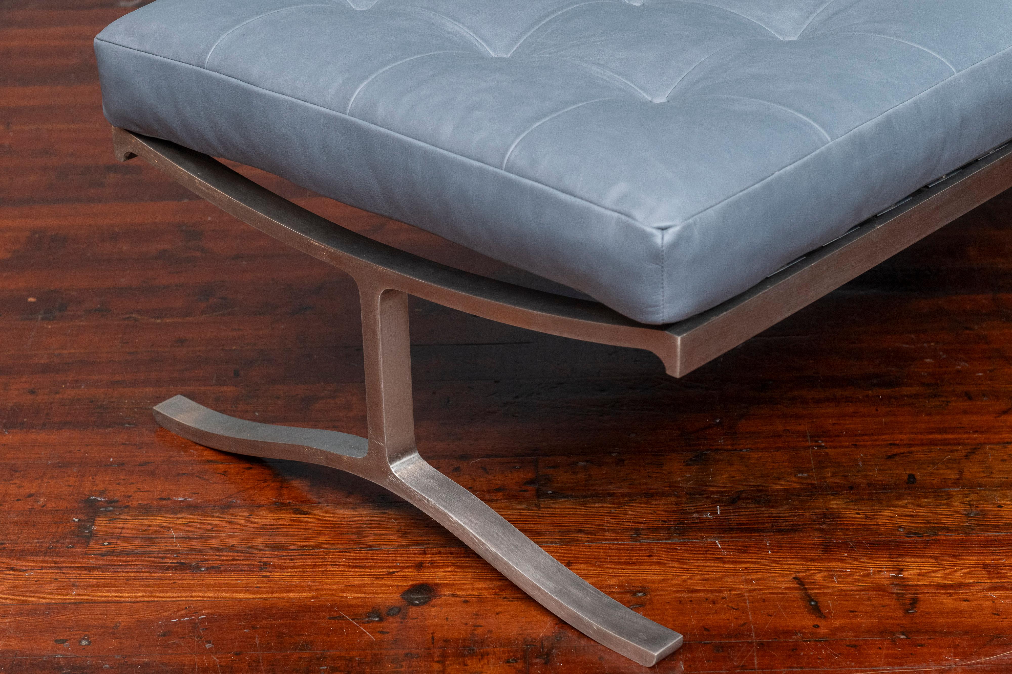 Nicos Zographos design stainless steel and leather upholstered bench. 
Classic modern design lines made with a high quality solid stainless steel frame in very good restored condition. Newly upholstered in high quality Italian ice blue leather in a