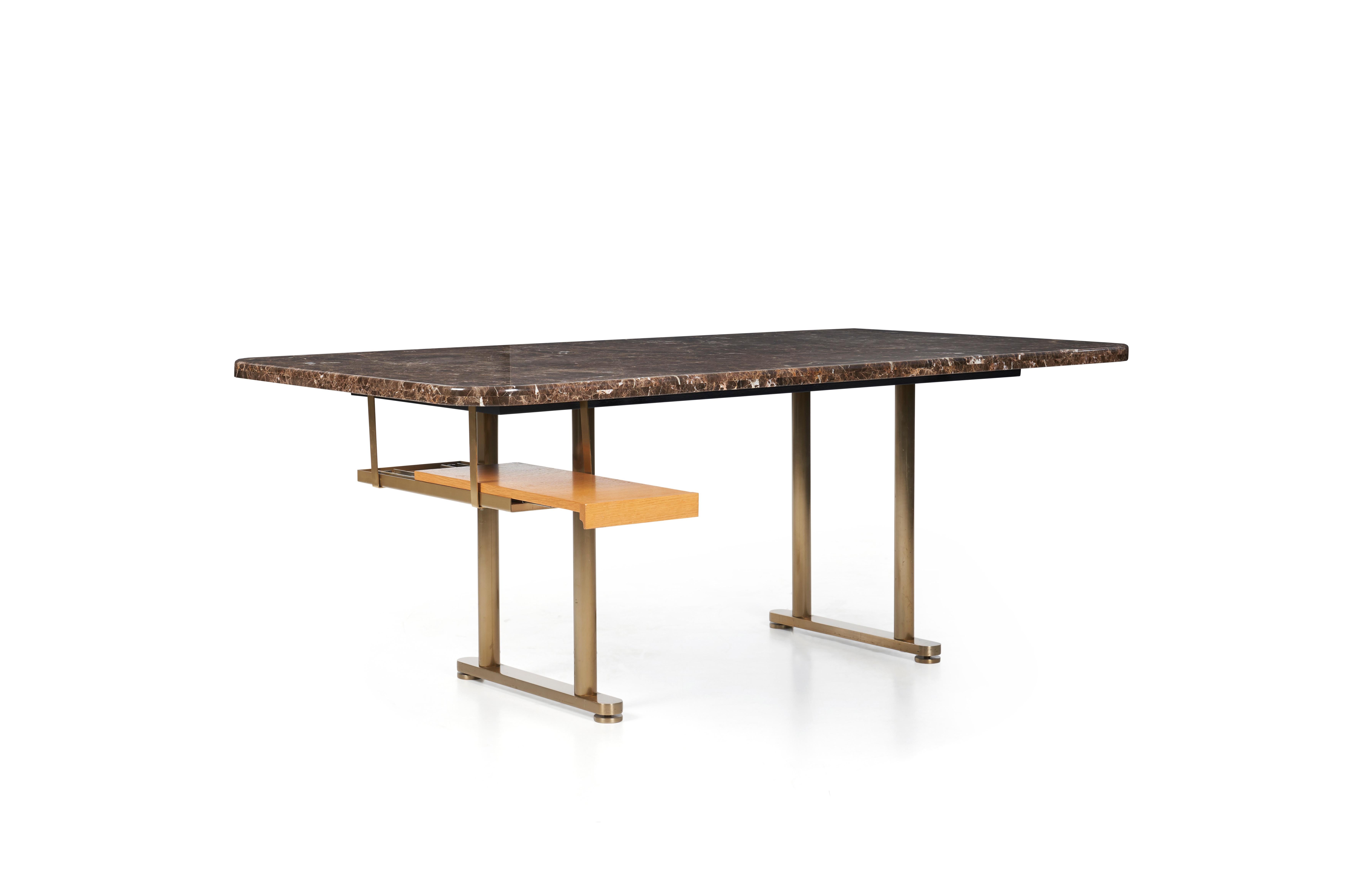 Zogrophos desk, slab of dark Emperador marble (brown with white veining).
Polished bronze uprights, legs have self leveling glides, with combed oak suspended pullout shelf.
 