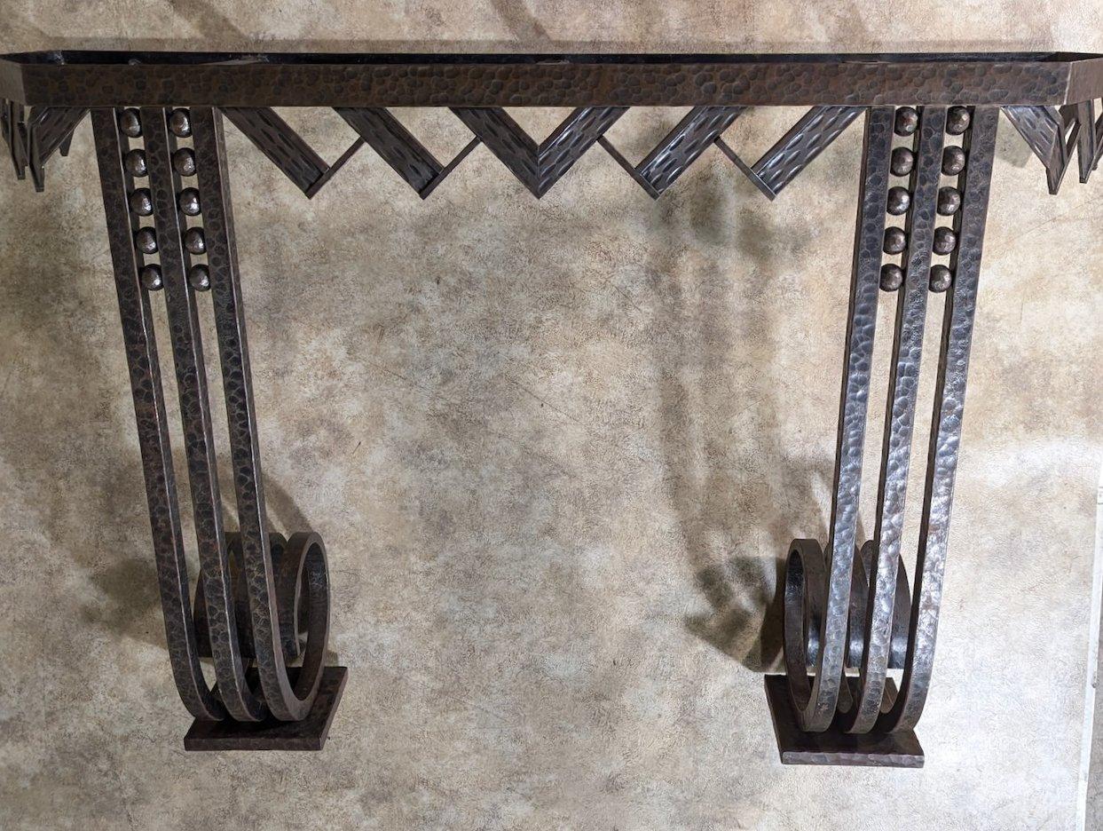 Classic French Art Deco console by Nics Freres, circa 1925, in forged iron. 51” wide x 34” high x 16” deep.  

The Nics brothers, Michel and Jules, were Hungarian metalworkerss and furniture makers, were active in Paris beginning in the later years