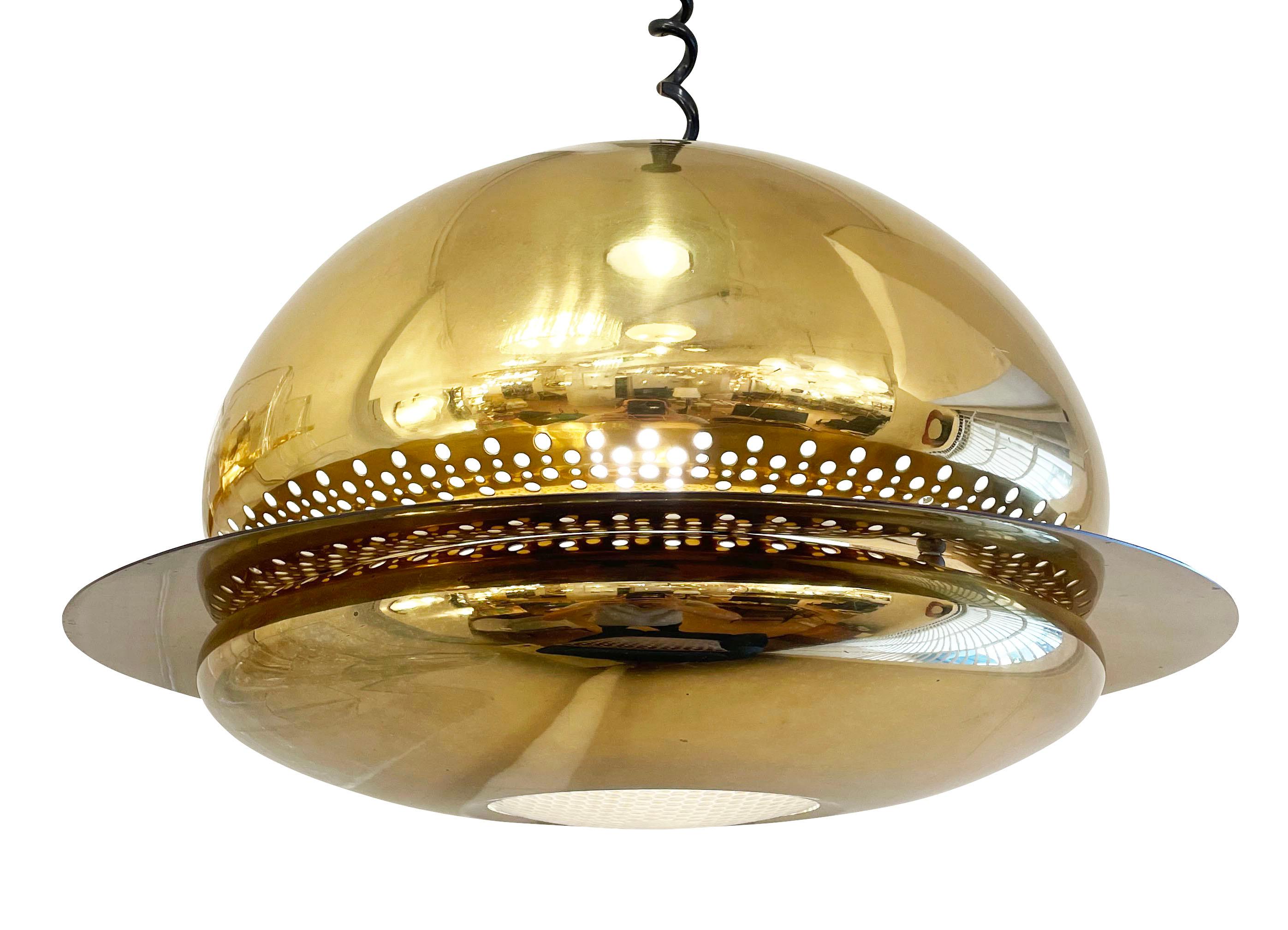 Nictea Pendant designed by Afra e Tobia Scarpa for Flos in 1971. Features an aged brass perforated frame with an optical glass lens at the bottom. Marked. Holds one E26 socket and height is adjustable.

Condition: 
Good vintage condition, minor