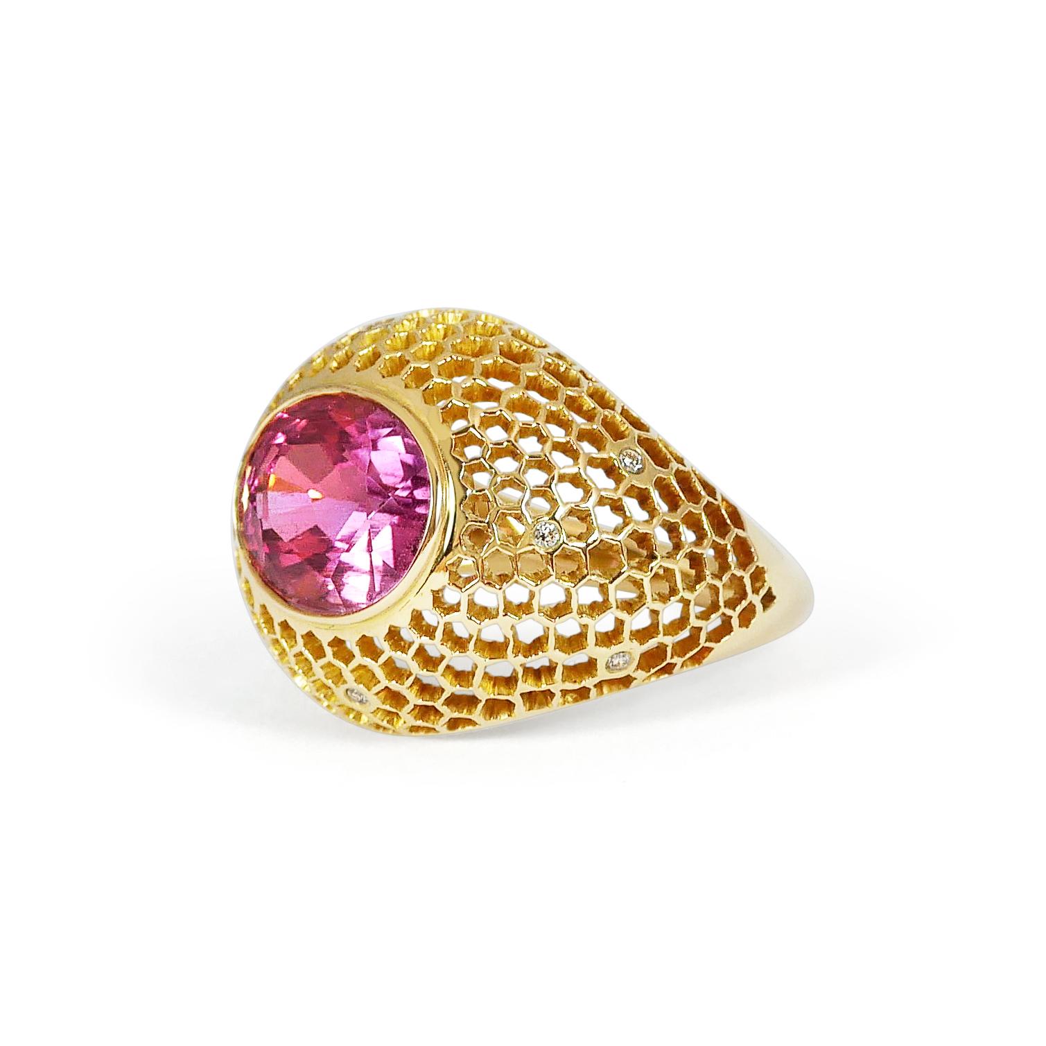 A beautiful 5,55cts Pink Tourmaline is nested on top of our preciously hand pierced gold and diamond 18k lace. This unique technique, inspired by our designer's childhood memories of lace makers of Normandie and the intricate architecture of Indian