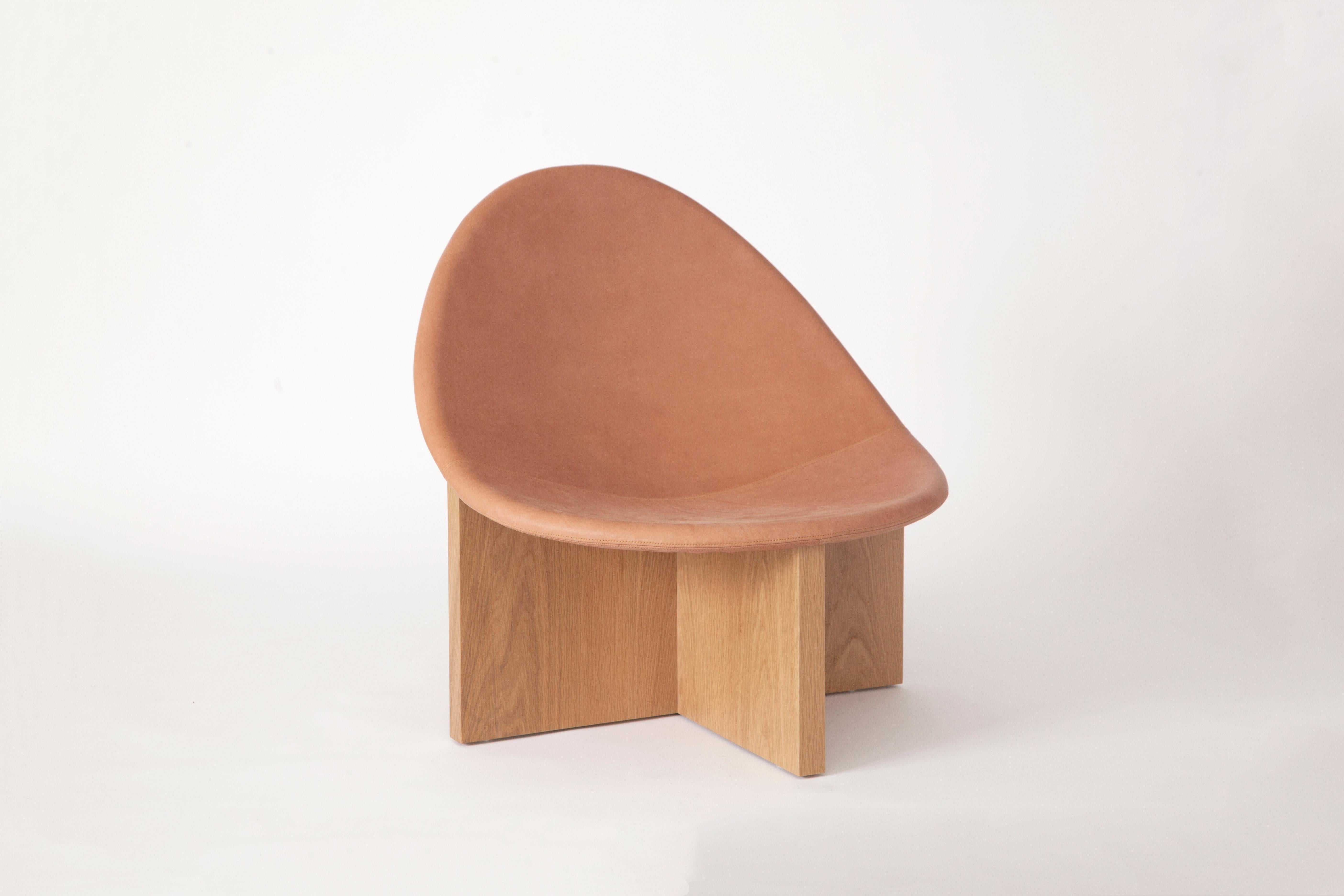 The NIDO chair was the result of playing with the juxtaposition of shapes. The egg-like shape of the leather upholstered wood seat nesting in the cross shaped solid wood frame, gives it the name NIDO, meaning nest in Spanish. The NIDO's strong lines