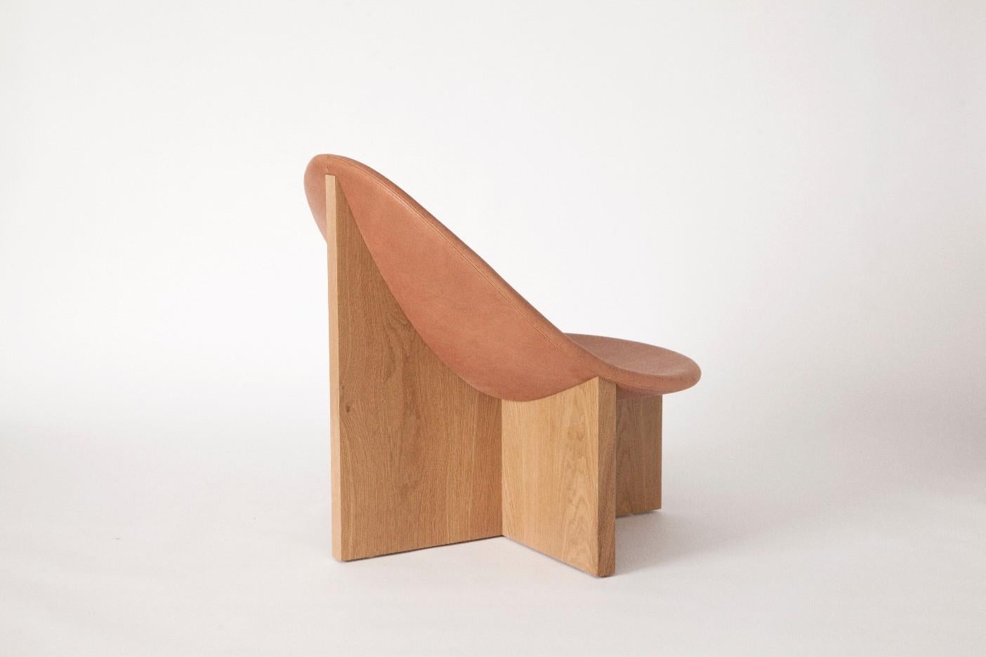 The Nido chair was the result of playing with the juxtaposition of shapes. The egg-like shape of the leather upholstered wood seat nesting in the cross shaped solid wood frame, gives it the name Nido, meaning nest in Spanish. The Nido's strong lines
