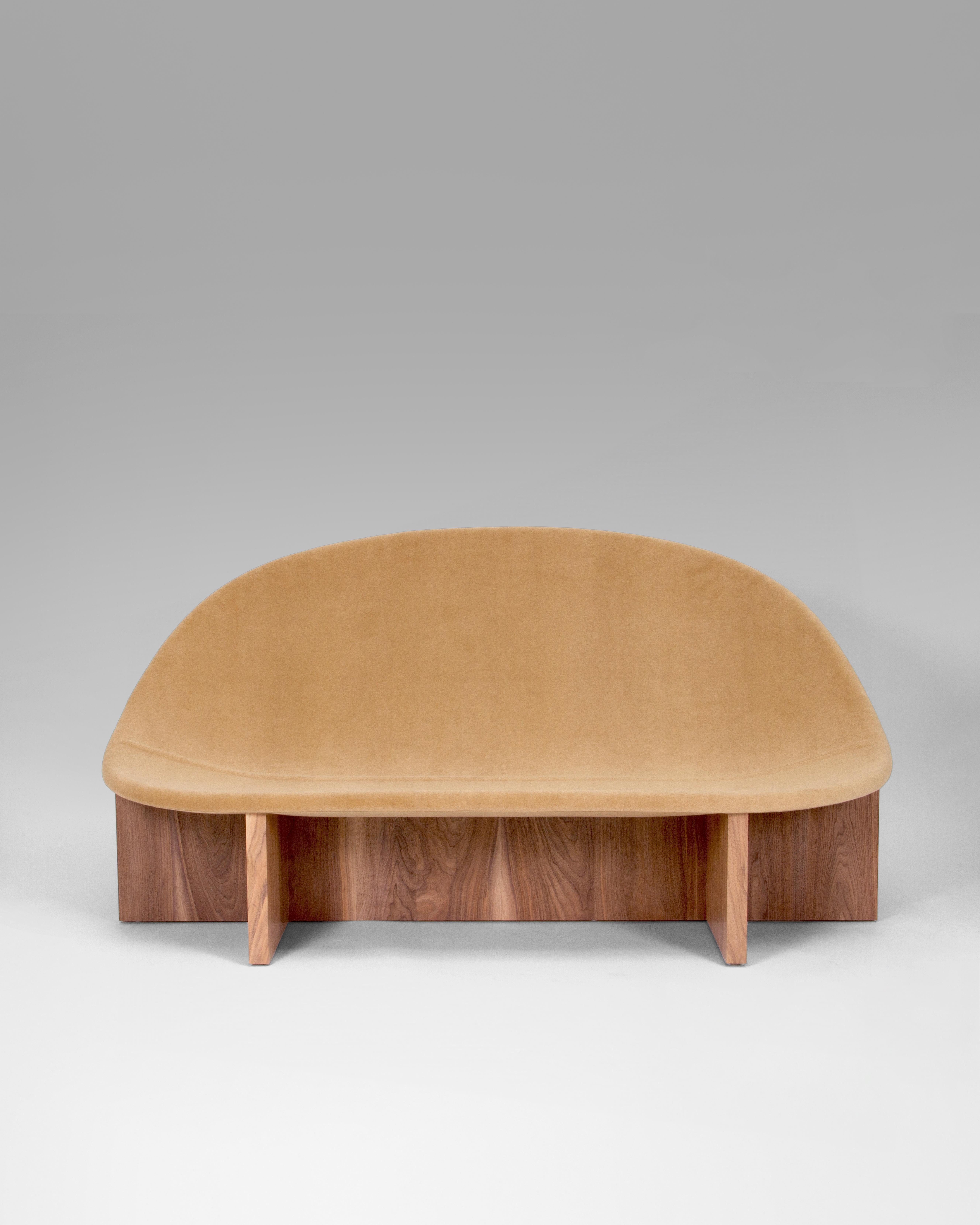 The sofa version of our bestselling NIDO Lounge Chair. The Nido sofa plays with the interconnection of shapes. Its wooden base and upholstered curved seating, eﬀortlessly combines comfort with form.
Customizations available upon request. COM and COL