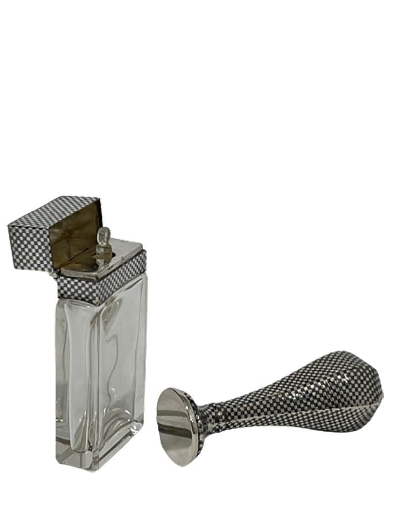 Niello Silver wax seal stamp and rectangular niello and crystal scent bottle

Niello Silver wax seal stamp and rectangular scent bottle with tilt cap and stopper. The scent bottle is Hall marked with the Dutch tax mark V, used during 1906-1953.
