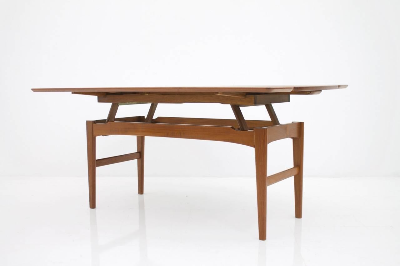 Niels Bach height adjustable coffee or dining table in teak by Randers, 1960s.
A multifunctional table that can be adjusted in height as well as in width. Simple but awesome mechanics. Very good condition.

Measures: Adjustable height from 55 cm