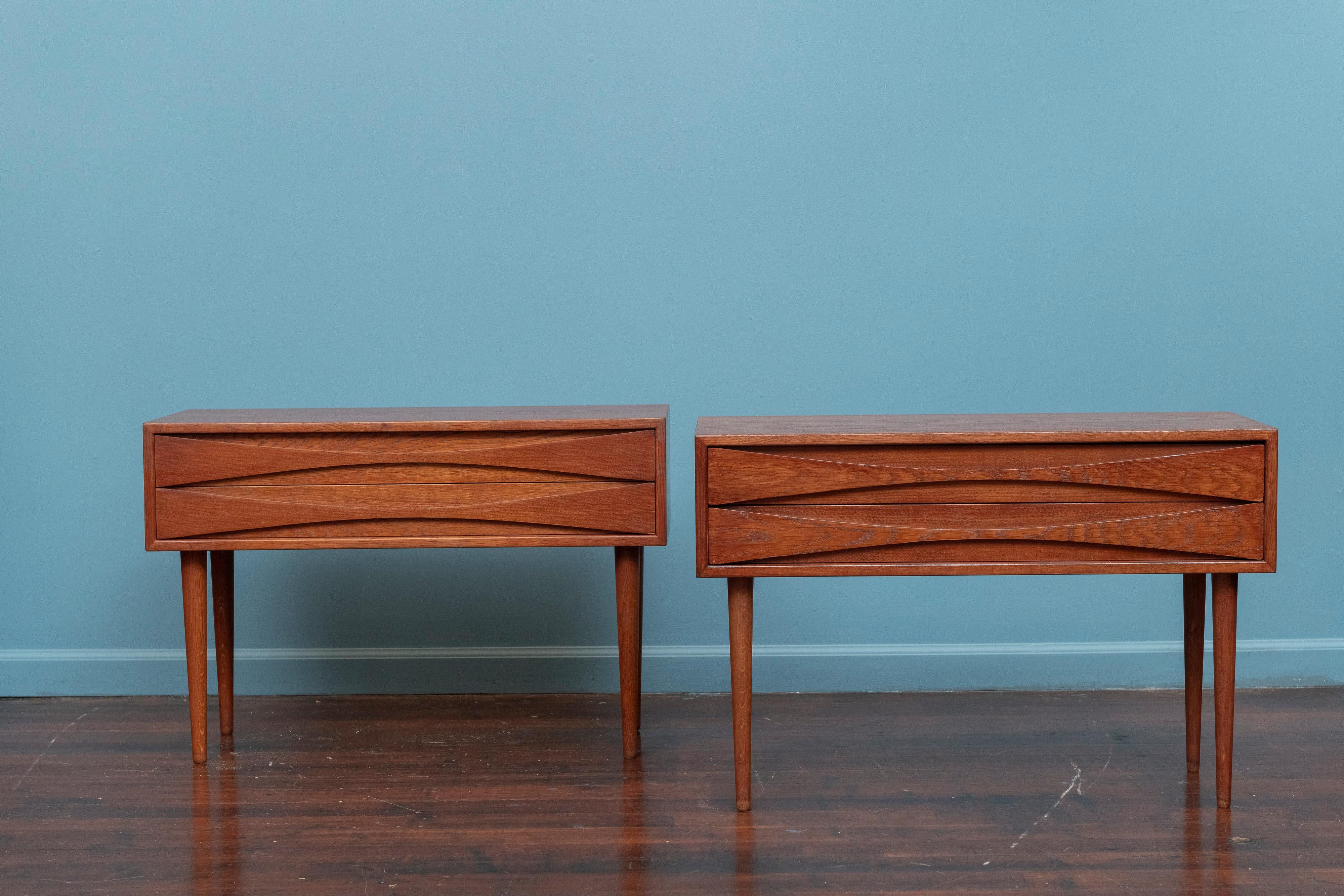 Pair of Niels Clausen design nightstands for NC Mobler, Sweden. Simple clean design nightstands with sculpted drawer pulls on tapering legs. Lovely condition ready to be installed and enjoyed.