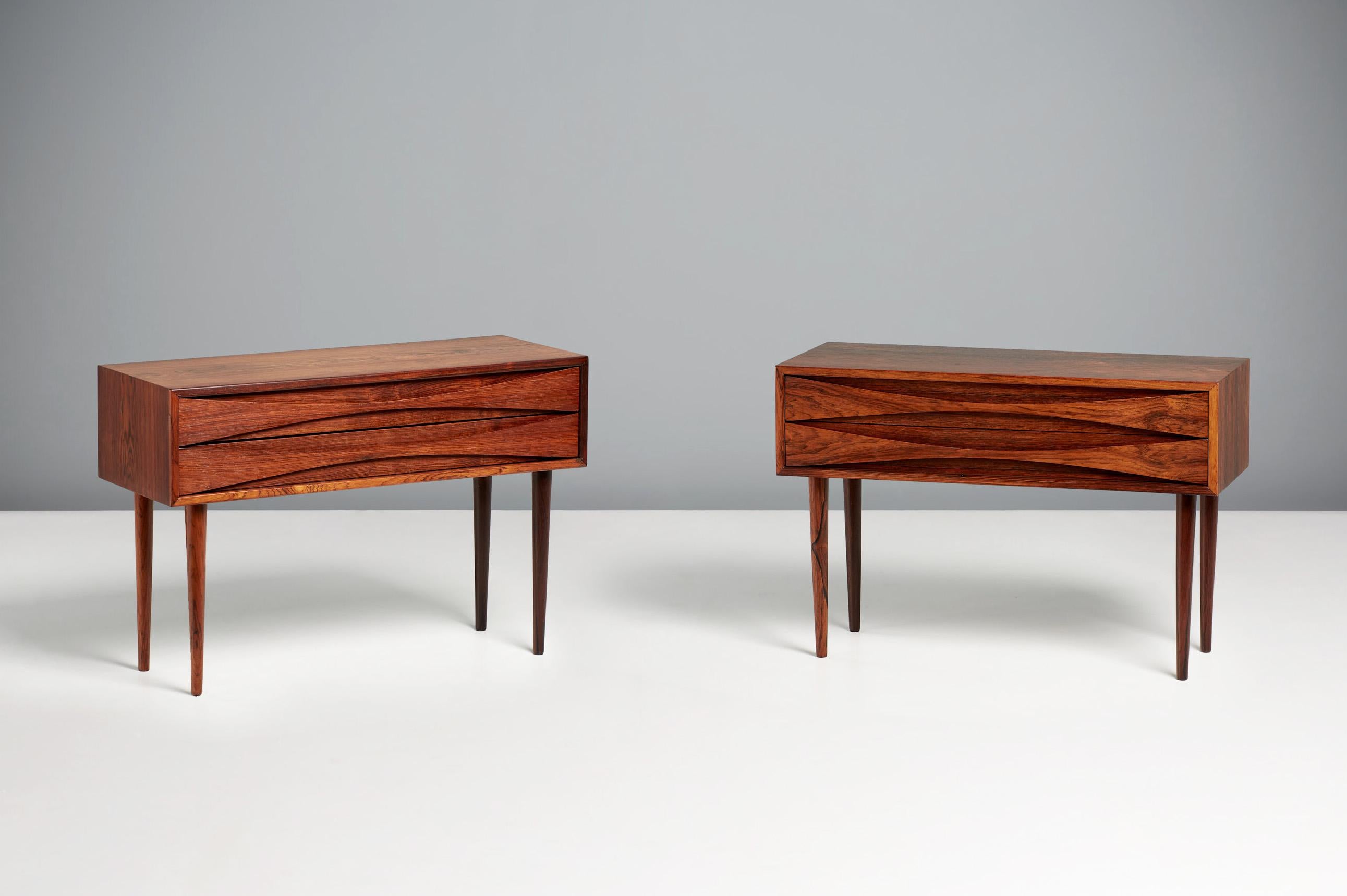 Niels Clausen Wide Bedside Chests, c1960s

Wide Rosewood cabinets by Niels Clausen for his own company: NC Mobler in Odense, Denmark. Produced c1960. Two drawers per cabinet with scalloped pulls and solid tapered legs. Oak lined drawers and