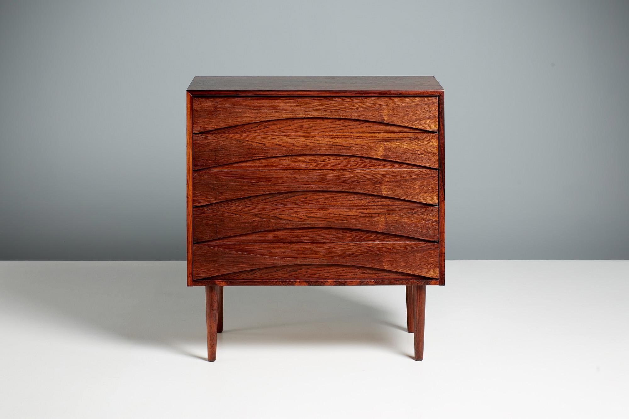 Rarely seen chest of drawers from Danish designer Niels Clausen, produced by his own company NC Mobler, c1960s. 

This chest features turned and tapered legs in solid rosewood. The chest frame is made of oak with highly figured rosewood veneer.