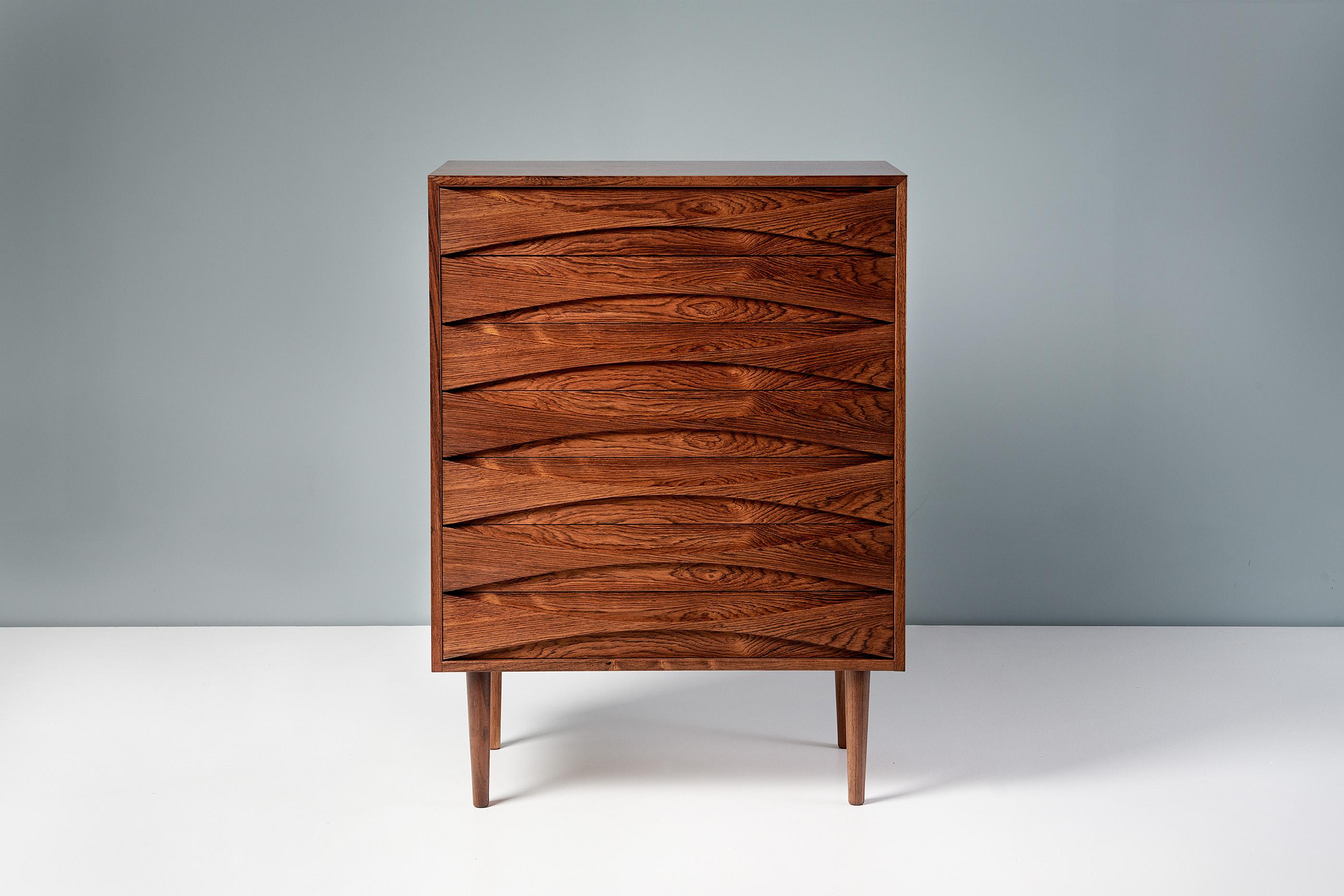 Rarely seen chest of drawers from Danish designer Niels Clausen, produced by his own company NC Mobler, c1960s. 

This chest features turned and tapered legs in solid rosewood. The chest frame is made of oak with highly figured rosewood veneer. The