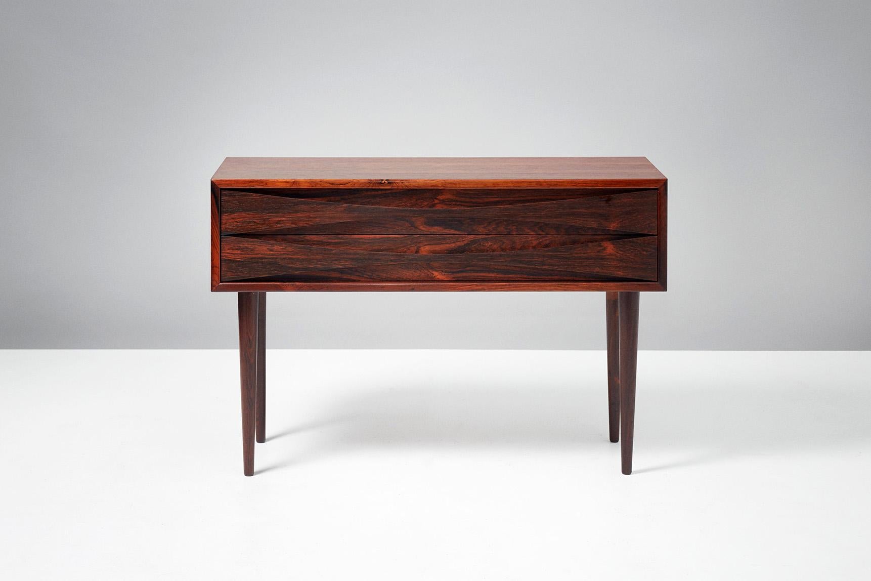 Niels Clausen

Rosewood bedside cabinet, circa 1960

Rosewood cabinet by Niels Clausen for NC Mobler, Odense, Denmark. Produced, circa 1960. Two drawers with scalloped pulls and solid tapered legs.
 