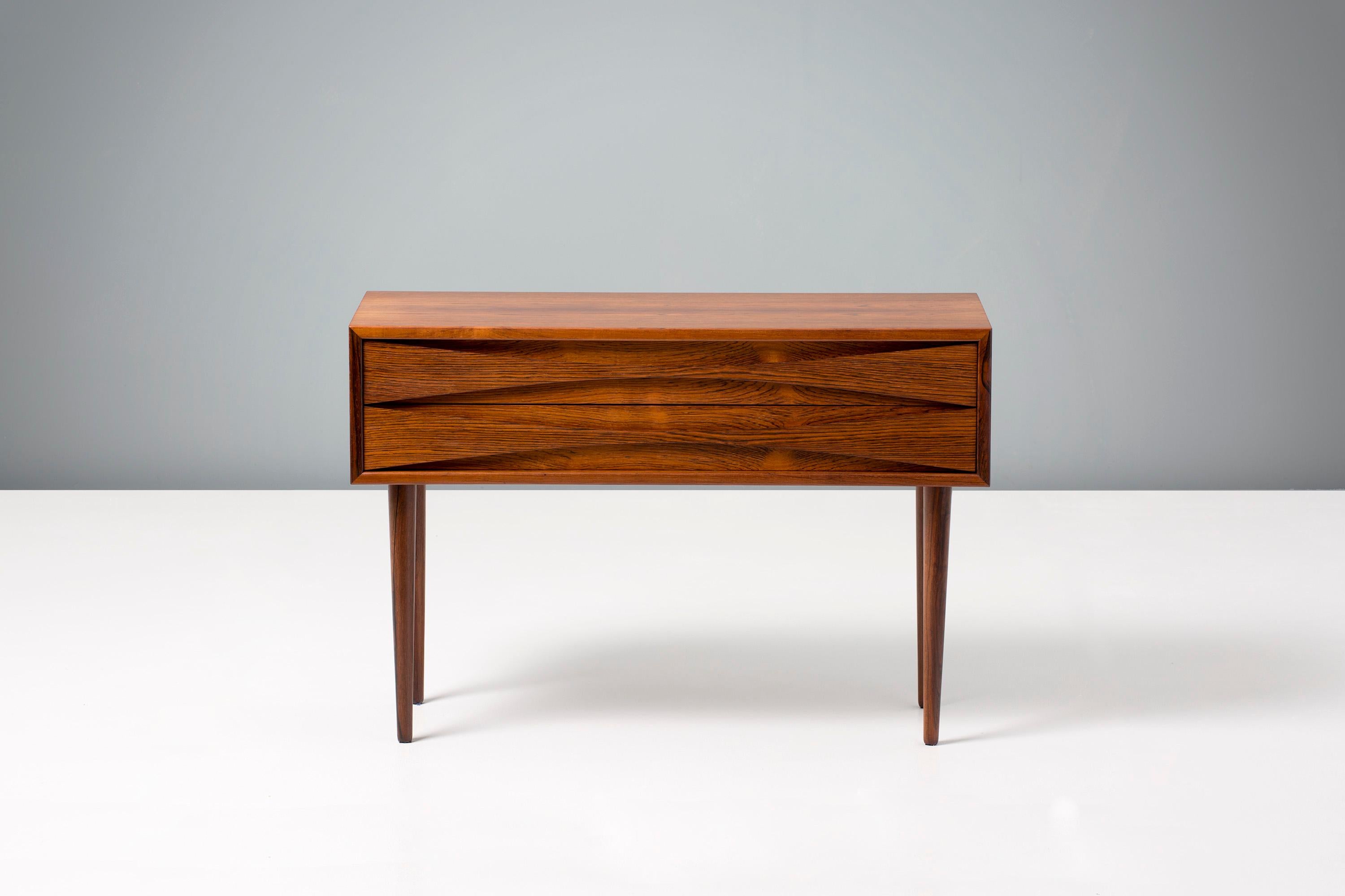 Niels Clausen

Rosewood bedside cabinet, circa 1960

Rosewood cabinet by Niels Clausen for NC Mobler, Odense, Denmark. Produced, circa 1960. Two drawers with scalloped pulls and solid tapered legs.
    