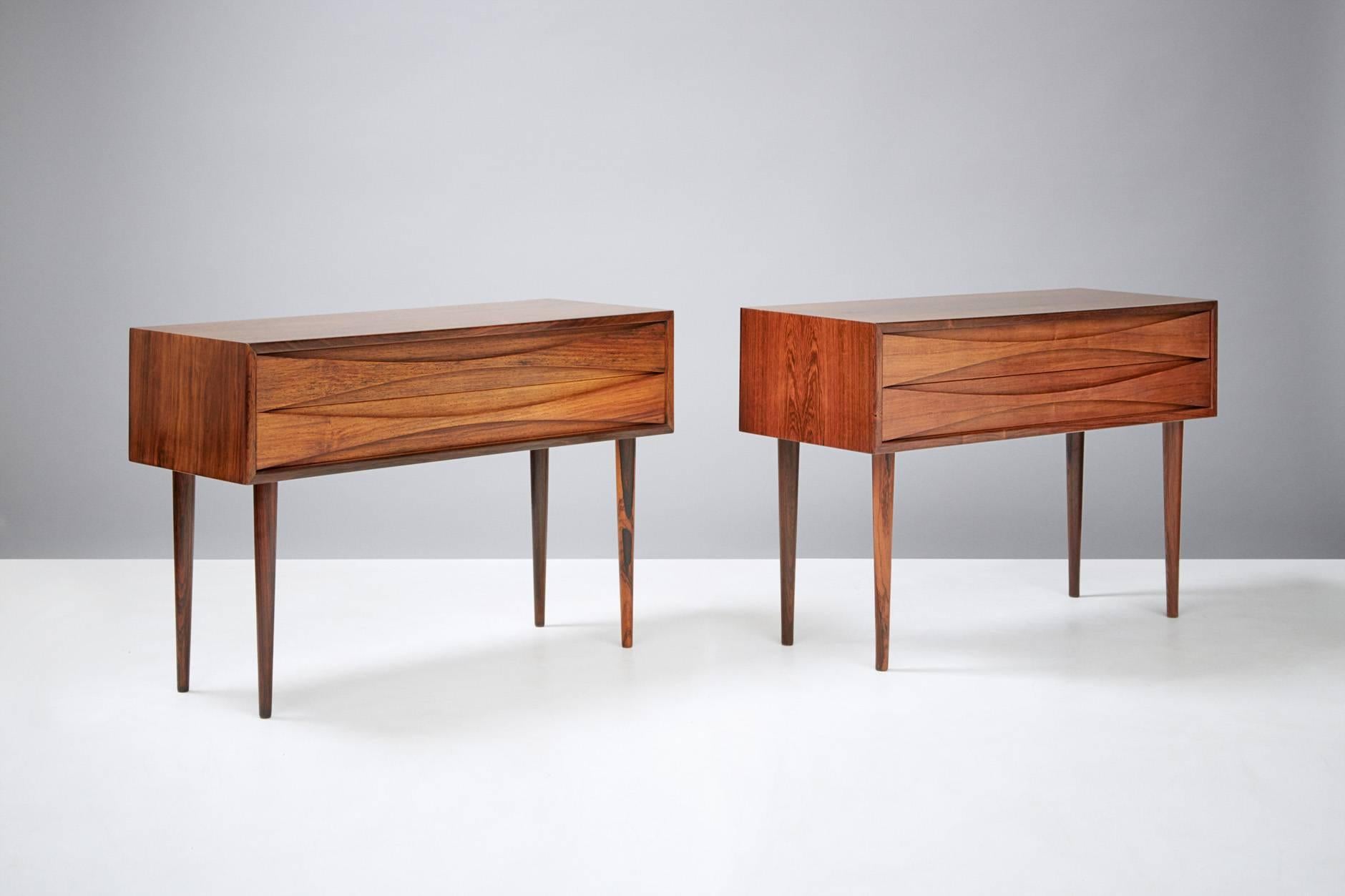 Pair of bedside cabinets, circa 1960

Rosewood cabinets by Niels Clausen for NC Møbler, Odense, Denmark. Produced, circa 1960. Two drawers with scalloped pulls and solid tapered legs.