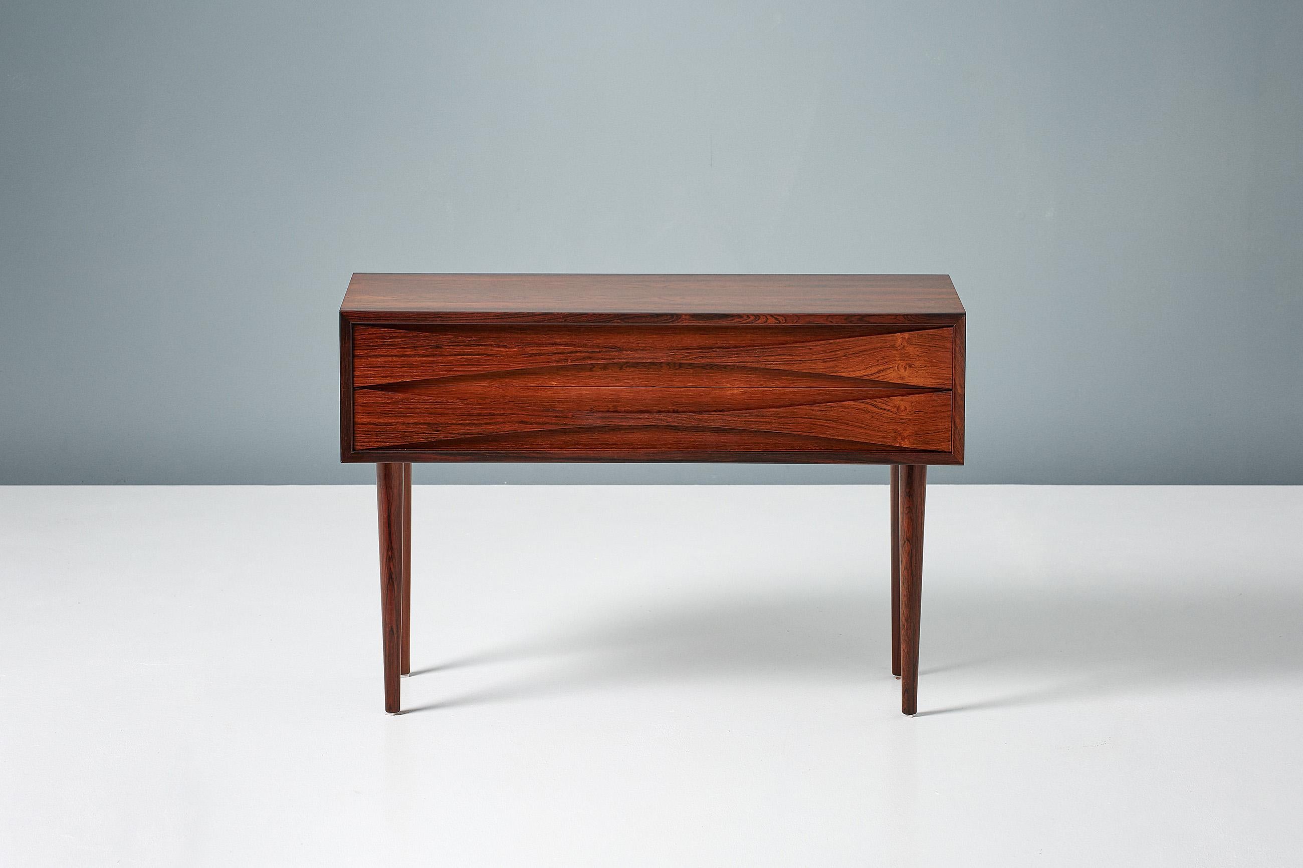 Niels Clausen

Low Chest, c1960

Rosewood chest by Niels Clausen for NC Mobler, Odense, Denmark. Produced c1960. Two drawers with trademark scalloped pulls and solid tapered legs.

Measures: W 80cm 
D 32cm 
H 54cm.