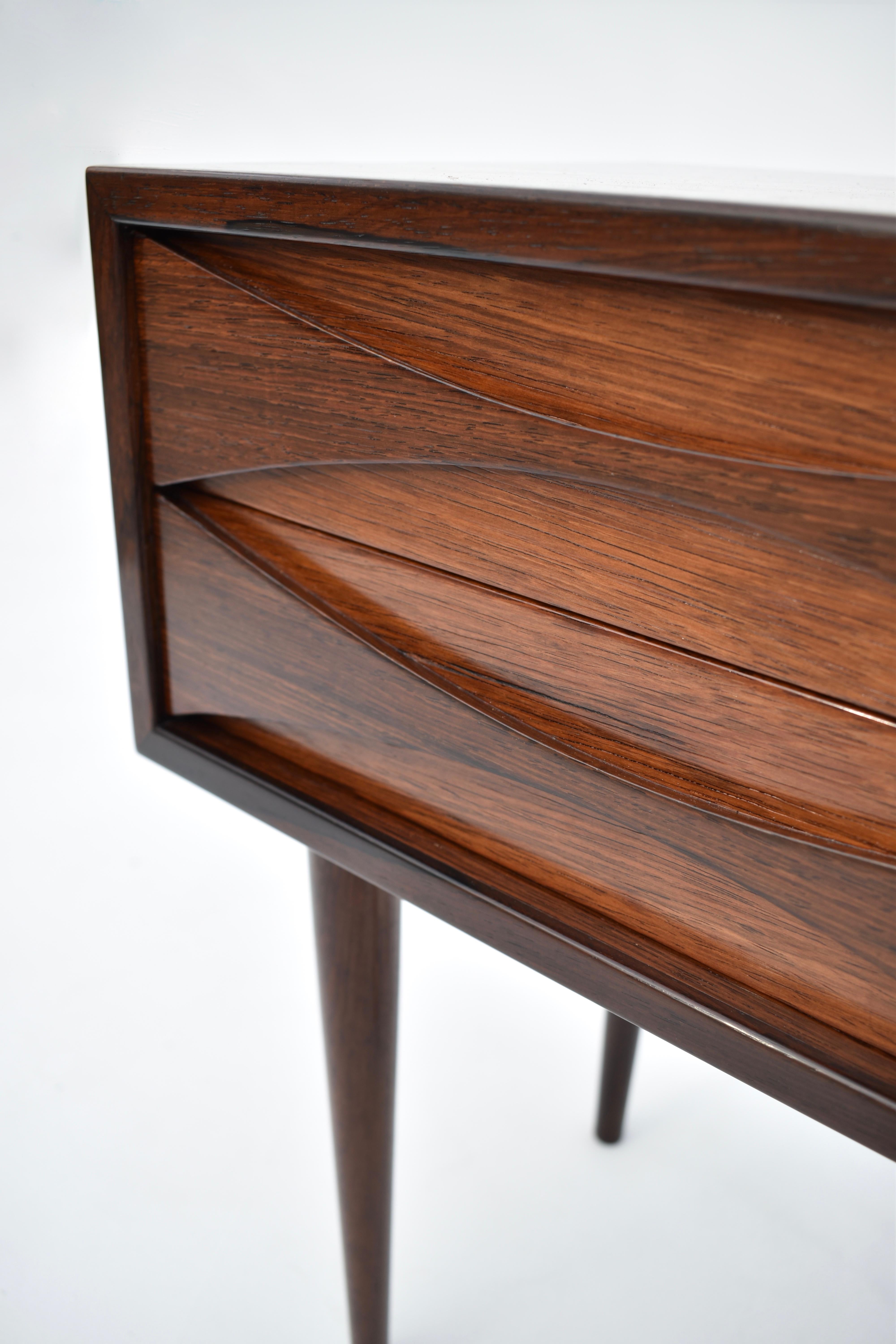 An absolutely charming little chest of drawers designed by Niels Clausen for N.C Mobler, Denmark.

A scarce and highly collectable design finished in Brazilian rosewood with finely sculpted drawer pulls.