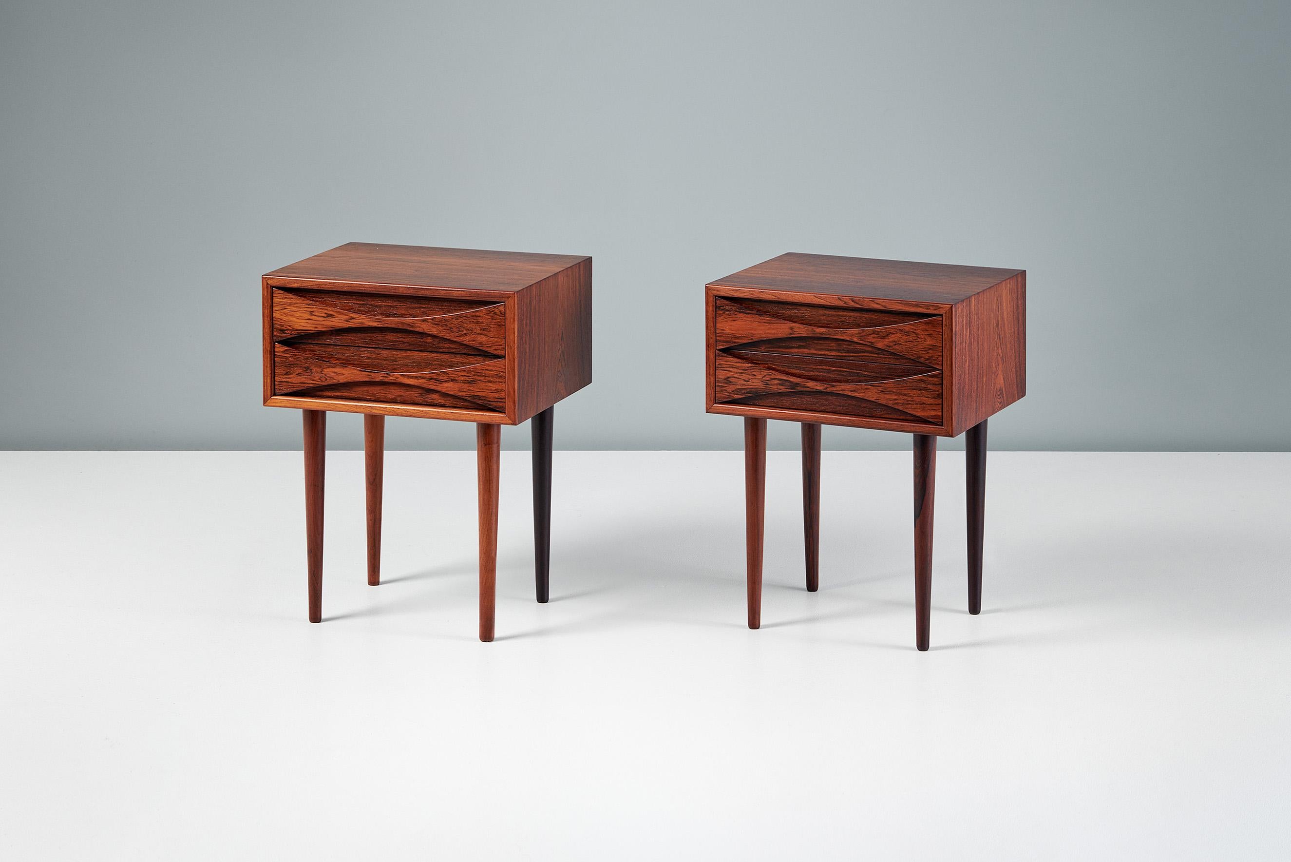 Rarely seen and highly collectible bedside cabinets from Niels Clausen for his own company NC Mobler. Each piece has solid turned rosewood legs with a cabinet built from oak and veneered with exquisite rosewood. The tops are book-matched across the