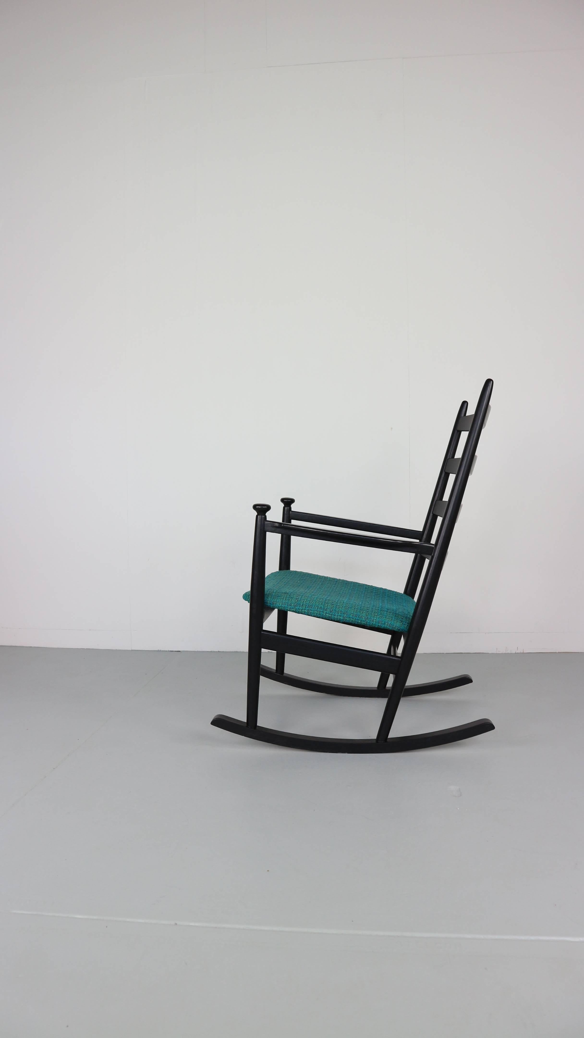 High-back Danish rocking chair by Niels Eilersen 
A wonderful example of a early 1960s rocking chair produced by Niels Eilersen of Denmark. 
Very generous proportions with a large ladder-back and super detailing with its subtle angles and circular
