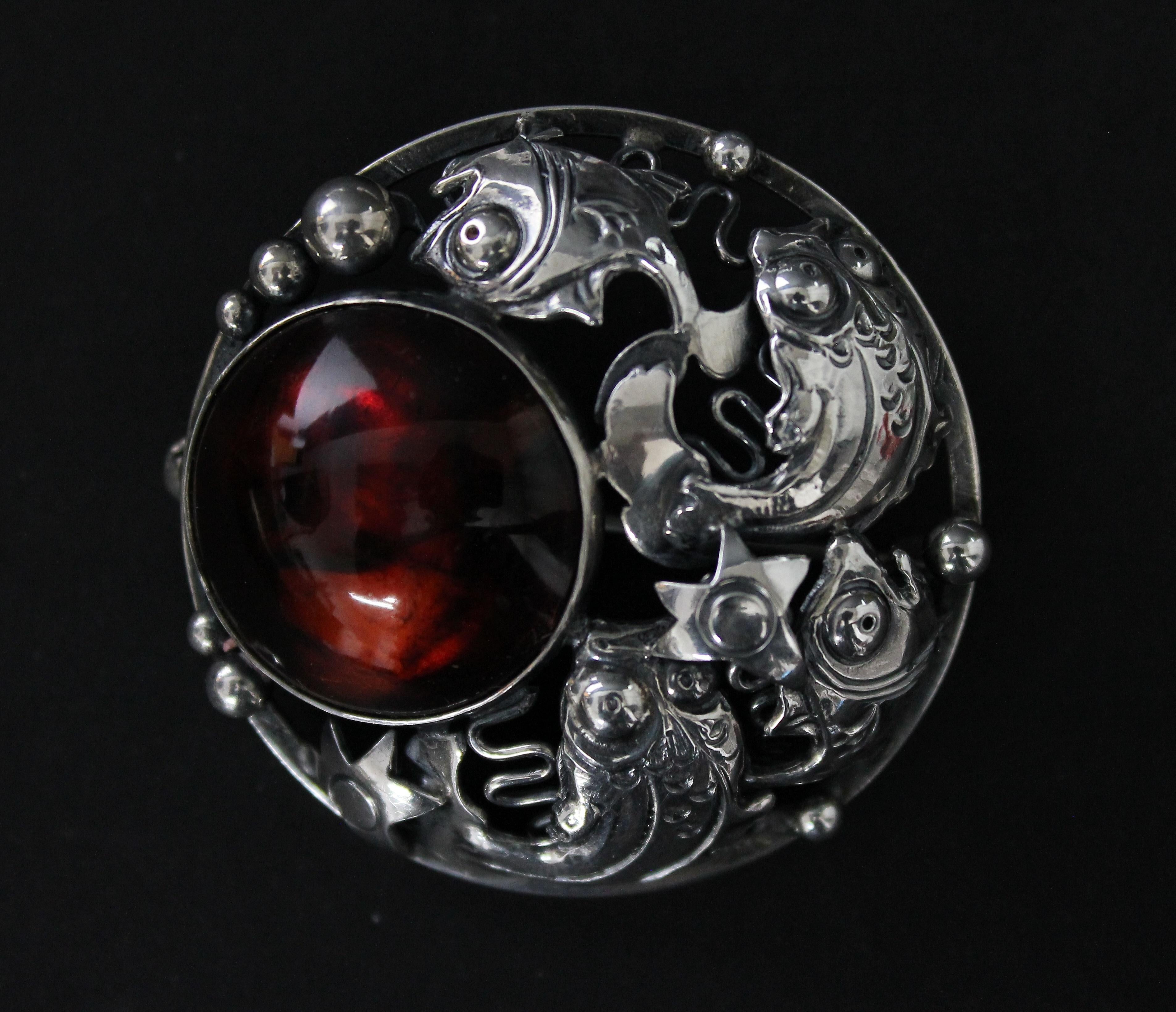 Very nice brooch by Niels Erik From. You can see different kinds of very detailed fishes in a desperate hunt for food. Very good condition. Sterling silver and amber. Fully marked.

NIELS ERIK FROM  1908-1982
Danish jeweler and silversmith Niels